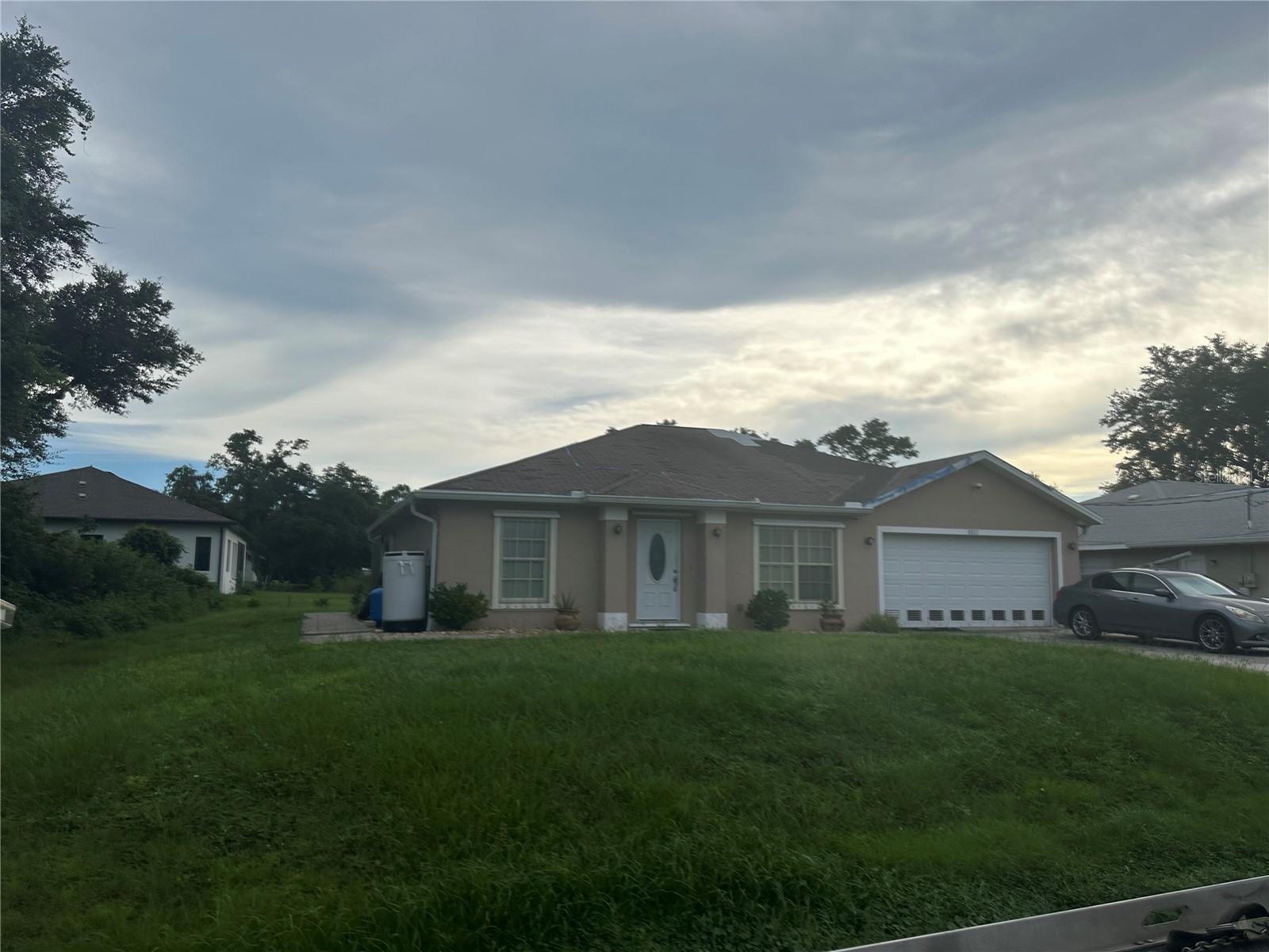 North Port Opportunity! Solid 2006-built home with 3 bedrooms, 2 baths, and a 2-car garage. Open-concept living area with vaulted ceilings, kitchen with pantry, and a split-bedroom layout for privacy. Primary suite includes walk-in closet and dressing area. Inside laundry and extra storage add convenience. Set on a private lot with mature trees. With some updates, this could be a great primary home, rental, or investment. Sold as-is.