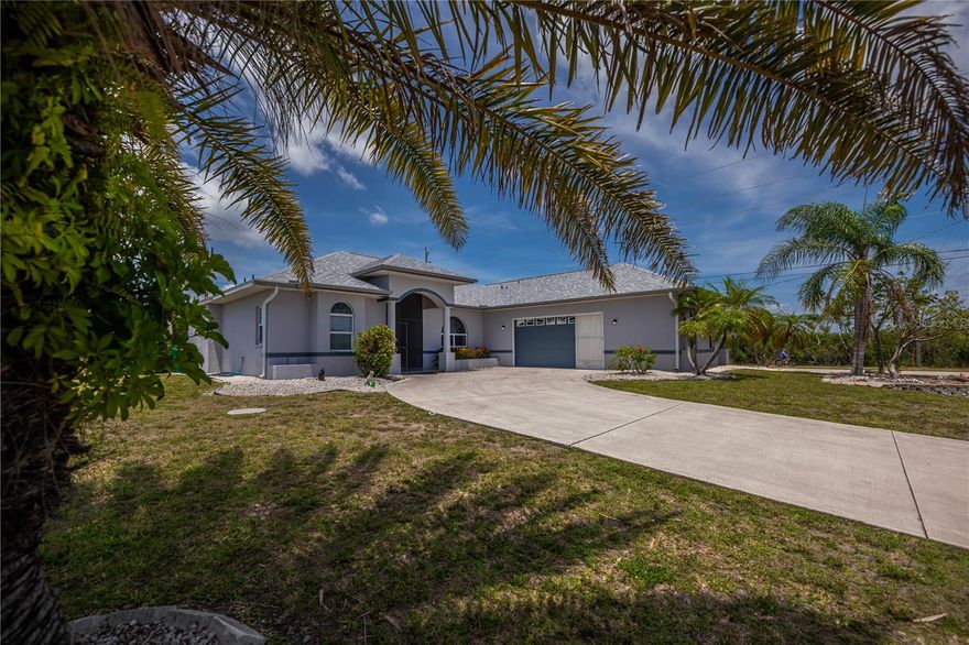 EXPERIENCE SERENE LAGOON WATER VIEWS FROM NEARLY EVERY ROOM in this exquisite South Gulf Cove residence, perfectly positioned across from the coveted St. Paul Linear Park and your gateway to endless nature adventures. Situated on an OVERSIZED CORNER LOT with EXTRA PRIVACY, this magnificent 3 bedroom, 2 bathroom, 2 car garage split floor plan spans nearly 2,500 square feet of air conditioned living space, combining luxurious comfort with exceptional curb appeal in an amazing location .

Step inside to be greeted by soaring ceilings, a grand entryway with leaded glass door foyer, and an abundance of natural light streaming through sunburst windows and sliding glass doors that open to an expansive screened lanai simply ideal for soaking in stunning sunsets and the tranquil water basin setting. Freshly painted, with tasteful updated lighting, planter shelves, and elegant rounded corners, this home boasts lovely finishes throughout and zero carpeting for easy maintenance.

Entertain effortlessly with two spacious living areas and a formal dining room, all designed to accommodate gatherings of any size. The chef’s kitchen is a culinary haven featuring abundant cabinetry, nice appliances, a farmhouse sink, and a generous breakfast bar adjacent to a cozy dinette with captivating water views.

The primary suite is your personal sanctuary, complete with private lanai access, dual closets, and an impressive spa inspired bath designed for relaxation. Two generously sized guest bedrooms offer large closets, ceiling fans, and share a beautifully appointed full bathroom.

The SUPERSIZED two car garage impresses with pocketing screens and an ADDITIONAL AIR CONDITIONED BAY ROOM perfect for hobby space or storage, complete with built in cabinetry including a secure safe that needs recoding. Practical amenities include an inside laundry room with ample cabinetry, a two year new roof, a six year old water heater, manablock plumbing, city water and sewer service, and room for a pool if desired.

Located in the highly sought after South Gulf Cove waterfront community, enjoy optional HOA amenities for just $120/year, including an air conditioned clubhouse, tiki huts, and vibrant social events. Outdoor enthusiasts will appreciate nearby parks featuring walking trails, boat ramps, fishing docks, picnic areas, and playgrounds.

Just minutes from world class fishing, championship golf courses, premier shopping, dining, and the pristine beaches of Boca Grande and Manasota Key, with access to over 55 miles of navigable waterways, this home offers the ultimate blend of nature, luxury, and convenience.

Don’t miss this rare opportunity to own your ideal Gulf Cove retreat with mesmerizing water and nature views, just steps from the waterfront park. Move in ready and available turnkey! DON’T LET THIS ONE SLIP AWAY. Schedule your private showing today!
