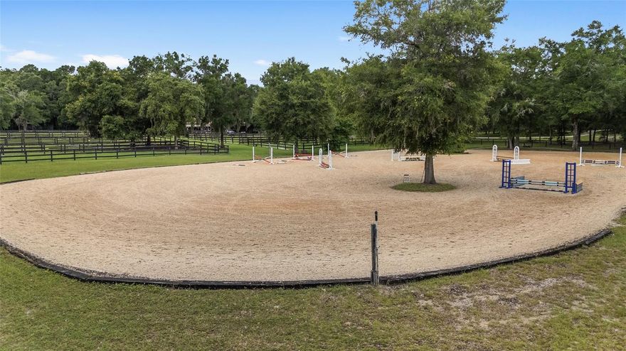 If you're looking for a farmette within minutes of the hustle and bustle of WEC and HITS where your neighbors can hear everything thats said outside, then this property is not for you.  If you're looking for privacy & seclusion: Training, Boarding, Living Oasis on 30+ Lush Acres then keep reading.  Imagine welcoming clients down a shady, tree-lined drive to a fully fenced, gated farm created for serious horsemen and built-in income. The property pairs professional-grade amenities with the serenity of Central Florida’s rolling landscape. Surrounded by large tracts and quiet neighbors. Center-Aisle Show Barn (21 Stalls) The main barn offers three oversized grooming stalls, a wash rack, and dedicated feed and tack rooms. An attached 1,200-square-foot, two-bedroom, one-bath apartment is ideal for a live-in manager or weekend retreat. Premium Training Facilities Anchoring the equestrian infrastructure is an irrigated 180 × 220-foot arena topped with GGT footing for dependable, year-round work—perfect for dressage lessons, hunter, jumpers or schooling youngsters. 19 irrigated paddocks with plenty of shade enclosed by three-board or top-board-and-wire fencing, provide flexible turnout, while a perimeter bridle trail invites hacking, conditioning sets, or a cool-down stroll beneath the oaks. Guest and Staff Housing Two charming cabins—each with 540 square feet—serve beautifully as Airbnb rentals, client, clinic or groom housing.  Multiple home sites ready to build your dream house.  Three RV hookups with water and electric welcome visiting riders, show clients, or seasonal campers. Income & Lifestyle Advantages Boarders, breeders, and trainers will appreciate multiple revenue streams, including stall leases, short-term cabin stays, and RV spots during Florida’s busy winter circuit. Wildlife-rich woods create privacy and a resort-like feel, yet the farm sits minutes from feed stores, veterinarians, and the vibrant equine hubs of Ocala (World Equestrian Center, HITS) and Gainesville. Ride Out, Venture Out Haul 20 minutes to Black Prong Equestrian Village and the Goethe State Forest trail system, or explore nearby Bailey Mine Trailhead. After a day in the saddle, enjoy local dining, shopping, and airport access—all without sacrificing the peaceful country vibe your horses crave. Ready to Elevate Your Program? Whether you breed sport-horse prospects, run a boarding operation, or need a winter training base, this versatile farm delivers the infrastructure, location, and charm to make your vision profitable from day one. Schedule your private tour and experience the possibilities firsthand.