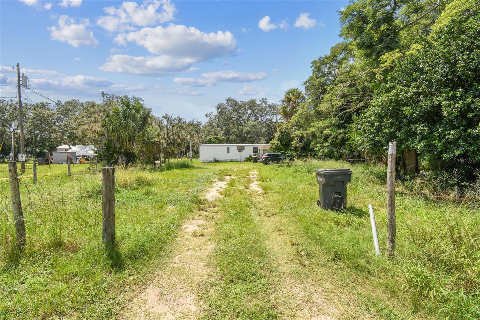 **TURNKEY PROPERTY-NO HOA/CDD** Begin collecting rent on day one with four *mobile homes 100% LONG TERM occupied on over 1.5 acres OR rent units until you're ready to build your own home! All tenants are on month to month leases allowing the new owner to adjust for market conditions. There is new construction breaking ground all around this area which will appreciate the value of the property. Each mobile home has its own septic and power; all units share one well. Two units have new metal roofs and interiors updated and two have fresh interior paint. All units have window AC. Income statements/rent rolls to be provided by Seller.
*2/1 $1095/mo #1101 NEW METAL ROOF
2/1 $1290/mo #1119 NEW INTERIOR PAINT
3/2 $1225/mo #1113 NEW METAL ROOF
3/2 $1295/mo #1107 NEW INTERIOR PAINT
EACH UNIT HAS ITS OWN SEPTIC AND POWER, ALL UNITS SHARE A WELL (EACH WATER SYSTEM HAS OWN POWER SUPPLY)
Seller finance is available. All room sizes/other information considered accurate. Buyer/Buyer's representative encouraged to verify all information independently. It is advisable to conduct due diligence with the county about potential land use (current and future), impact fee credits, and/or exemptions.