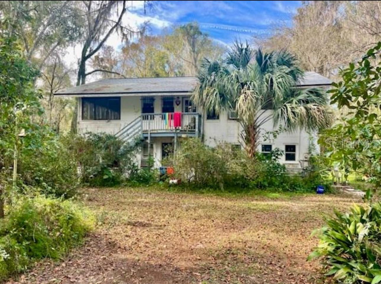 This is ONLY a combined sale along with MLS GC531895, GC531896 and GC531897Â where the sellers are selling them collectively to complete this subdivision. This house is NOT for sale individually.
This is offered as part of a legal subdivision that offers an opportunity to a builder/developer to bring up to seventeen homesites to market, conveniently located three miles south the University of Florida (UF), UF Health and Associated Medical Colleges (Medicine, Pharmacy, Dental, Nursing, and Veterinary) the VA Medical Center. The site is just north of Paynes Prairie and the passive and active recreational opportunities it offers. Access to I-75, downtown Gainesville, and other key community amenities.
Over the past several months, the family heirs have performed an extensive Due Diligence process and worked with Alachua County’s Departments of Growth Management, Environmental Protection, and Public Works to define a path to completion of this legacy Subdivision. Based on the property’s unique location and modest size, the project will not be required to provide connections to Gainesville Regional Utilities for potable water and sanitary sewer. In addition, based on the extensive and beautiful tree canopy, Alachua County staff have reviewed current survey data and visited the site to review tree canopy and the overall site. Alachua County Public Works Department staff have directed us to use the minimum roadway standards, contained within the adopted Corridor Design Manual, and construct a private roadway serving the homesites. CHW staff have discussed the County’s direction with Alachua County Fire Rescue, and their request is for adequate width for first responders and larger’s trucks outriggers should they need to respond to an onsite emergency.
CHW, now NV5, has performed the Due Diligence and Survey work, which is available for review and reference.