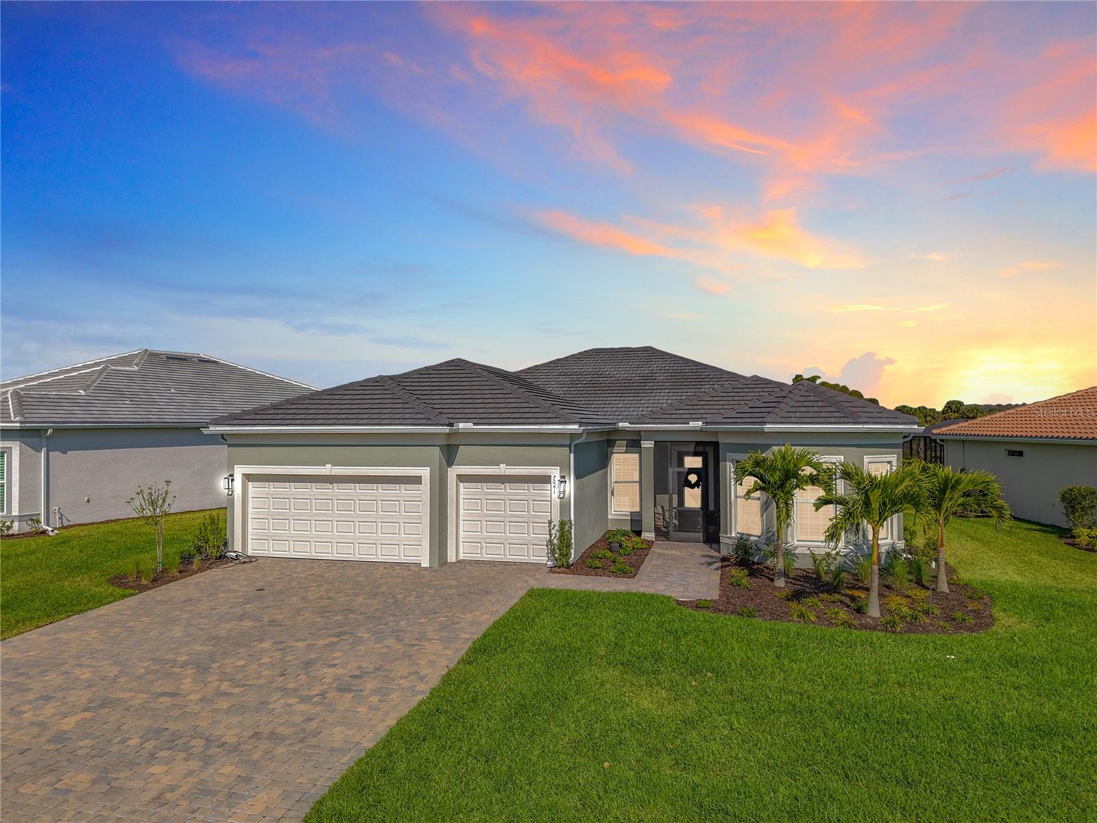 Step into magazine-worthy elegance with this 2024-built Stellar model by Pulte, part of the prestigious Echelon Series. Less than a year old, this exceptional 3-bedroom + office/den home showcases impeccable design and craftsmanship, with high-end finishes and breathtaking lake views that set it apart.
From the moment you arrive, the decorative brick-paved driveway and tile roof exude sophistication. Inside, the tray ceilings, quartz countertops, and designer lighting create an ambiance of refined luxury. The chef’s kitchen is a showstopper, featuring upgraded 42-inch cabinetry, a stylish designer backsplash, a built-in oven and microwave, a gas cooktop, and an expansive island.
Both ensuite bedrooms offer spa-like retreats with walk-in showers, while the full stone wall fireplace adds warmth and elegance to the open living area. The seamless indoor-outdoor living experience is elevated with a zero-corner sliding glass door leading to a covered lanai, screened-in pool, and spa—all overlooking a mid-lake view of a picturesque island, home to majestic eagles and ospreys.
Situated on a premium lot, this home also boasts all-tile flooring (no carpet!), a 4-ft extended 3-car garage with an electric car outlet, whole-house gutters, and a state-of-the-art "Tubes in Wall" pest defense system and Sentricon termite bait system. The automatic sprinkler system ensures lush landscaping year-round.
Beyond your front door, Del Webb Oak Creek redefines resort-style living. Enjoy the grand clubhouse, resort pool, pickleball and bocce courts, a cozy fire pit lounge, cutting-edge fitness center, and group exercise studio. With endless social activities and community events, every day here is an opportunity for relaxation, recreation, and connection.
Don’t miss your chance to own this designer-inspired sanctuary in one of the most sought-after 55+ communities!