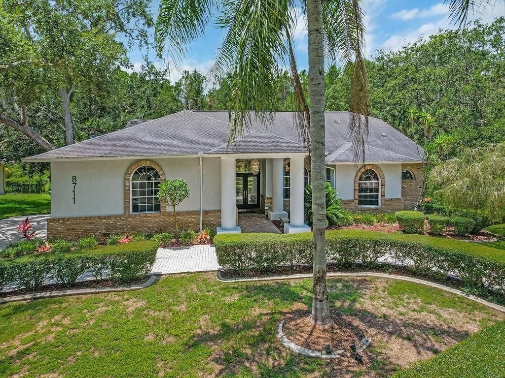 Photo of 8711 Crescent Forest Boulevard, New Port Richey, FL 34654 (MLS # TB8474866)