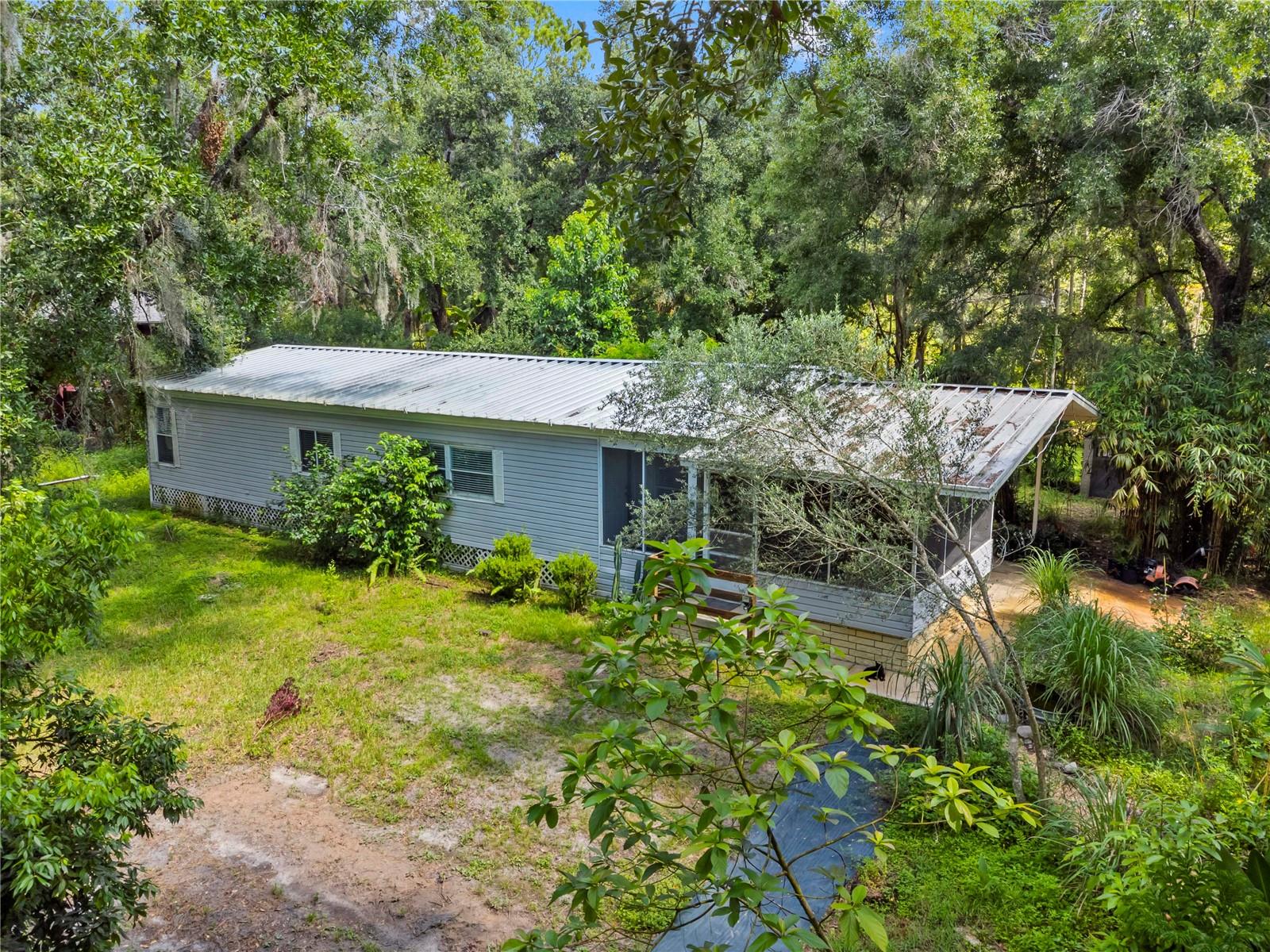 Tired of the hustle and bustle? Welcome to your dream country escape on 1 peaceful, agricultural-zoned acre—just minutes from shopping, dining, and medical facilities, yet worlds away from the noise. This beautifully maintained 2-bedroom, 2-bathroom doublewide home offers 1,404 square feet of comfort, privacy, and potential—with NO HOA restrictions to limit your vision.
Step inside to discover new wood-look laminate flooring throughout, a spacious laundry room with cabinet storage, and a thoughtfully updated interior that blends cozy country vibes with functional upgrades. Enjoy peace of mind knowing all plumbing has been replaced with durable PVC/CPVC—no polybutylene here. A new well pump was installed in 2025, and the metal roof has held strong with no issues during hurricanes. Plus, it’s not in a flood zone and features a fully fenced yard—ideal for pets, gardening, or simply soaking up the outdoors.
The open floorplan flows from a light-filled lanai into a generous great room, leading into the formal dining area. The oversized master suite is a true retreat with a huge walk-in closet, twin-sink vanity, soaking tub, separate shower, and a linen closet. The second bedroom is also spacious and features its own walk-in closet.
Step out back to a concrete patio, perfect for grilling, entertaining, or relaxing under the stars. With well and septic, you'll enjoy low monthly utility costs, and the ag-zoning offers endless opportunities—think gardening, hobbies, or even small-scale farming.
This is more than just a home—it's a lifestyle. Whether you're seeking space to spread out, start a homestead, or simply enjoy a quieter pace of life, this slice of country charm in Zephyrhills is ready to welcome you home.