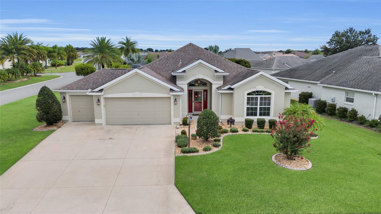Pristine Villages Retreat in La Belle.Discover this beautifully maintained 3-bedroom, 2-bath residence in the highly desirable Village of La Belle, just moments from Belle Glade Country Club and steps from the Atlas Canine Recreation Dog Park. This CORNER LOT home shows like a model with thoughtful upgrades and a layout perfect for both entertaining and everyday living. From the moment you arrive, you’ll notice the meticulous landscaping and inviting curb appeal. Step inside to soaring ceilings, crown molding, luxury vinyl plank and tile flooring, and an abundance of natural light. The spacious living and dining areas flow seamlessly into the enclosed Florida room with wall-to-wall windows, creating a bright retreat year-round. The chef’s kitchen offers white cabinetry, stainless steel appliances, a wine rack, breakfast bar, and casual dining nook, all designed with function and style in mind. The oversized primary suite features a tray ceiling, spa-like bathroom with dual vanities, an expansive walk-in tiled shower, and a huge custom closet system. Guest bedrooms are generous in size - one complete with built-in shelving and desk, ideal for a home office or hobby space. Step outdoors to enjoy a pergola-covered patio, perfect for relaxing or entertaining. A laundry room with cabinetry and a garage featuring built-in shelving provide practical convenience, while the pristine condition throughout ensures move-in readiness. This exceptional home combines elegance, comfort, and location - delivering the very best of The Villages lifestyle. Keep in mind- that just about anywhere you need to go in The Villages- YOU CAN TAKE YOUR GOLF CART!!!