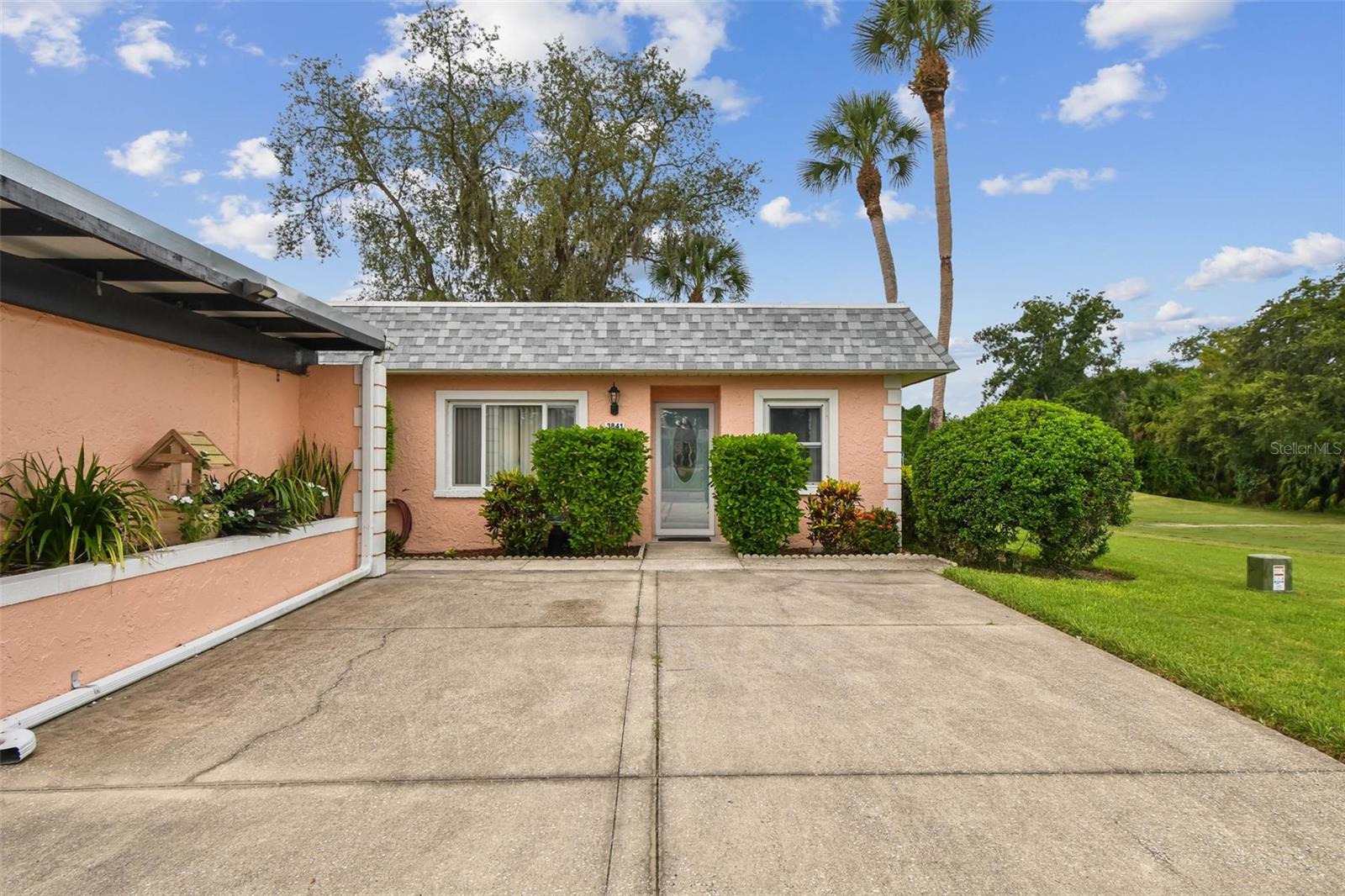 This beautifully updated end-unit villa offers expansive golf course views on two sides and a bright, open layout. Recent improvements include new windows and doors (2009), a new hot water heater (2012), and a new A/C system (2016). The gourmet kitchen features granite countertops and overlooks the dining and living rooms, creating an ideal space for entertaining. A split-bedroom plan provides privacy, while both bathrooms have been tastefully renovated. The master suite includes generous closet space, and the villa also offers a convenient stackable washer and dryer. Laminate wood-look flooring and a fully furnished interior make this home move-in ready. Living and entertaining space is extended through living room sliders to a large patio with sweeping golf course views—no neighboring homes in sight. The end-unit location also brings in natural light through a large dining room window unique to this floor plan. Parking is convenient with a covered carport plus two additional open spaces right in front of the villa. The community welcomes all ages, allows two pets under 25 lbs, and permits rentals. Residents enjoy resort-style amenities including two pools, a clubhouse, restaurant, and pro shop, all within a secure, gated setting. This villa offers the perfect blend of comfort, convenience, and country club living at Seven Springs Golf and Country Club in the thriving Trinity community. HOA fee covers water, sewer, exterior maintenance, trash, cable, and internet. Disney+, Paramount+, Hulu, Peacock, ESPN unlimited, FOX One, AMC+ and HBO Max are also included. Premium home site! beautiful home! Fabulous community! Make it yours!