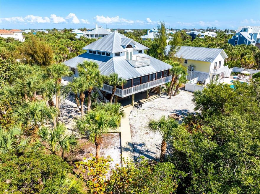 Welcome to 51 Palm Drive located on beautiful Palm Island, Florida. This waterfront island home offers the ultimate in coastal living, combining direct Gulf access, stunning sunset views, and the privacy of a barrier island lifestyle with over seven miles of pristine sandy beaches just moments away.

Situated on an oversized corner lot, this 3-bedroom, 2-bath residence features a private dock on a saltwater canal with no bridges to the Gulf of Mexico—a true boater’s dream. Enjoy effortless days on the water with quick access to world-class fishing, boating, and island hopping.

Inside, the home showcases an open-concept floor plan designed for relaxed coastal living, with a spacious great room, beautiful Spanish tile and wood flooring, and warm knotty pine walls and ceilings that create a classic island feel. The remodeled kitchen is both stylish and functional, featuring granite countertops, stainless steel energy-efficient appliances, under-cabinet lighting, wine rack, and a granite topped kitchen island perfect for entertaining.

Wake up to Gulf views and breathtaking sunsets from the top-floor primary suite, complete with a beautifully updated travertine bathroom, dual vanities, garden tub and a rain shower. Outdoor living is just as inviting with a screened second-floor porch, fire pit, a charming hexagon deck nestled among mature palms, and lush Florida-friendly landscaping.

Additional features include a metal roof with radiant barrier, 15 SEER Trane A/C system with UV light and connection to public water and cable—offering comfort, efficiency, and peace of mind.

With ample room to add a pool and positioned as one of the best values for a 3-bedroom waterfront home with direct Gulf access on Palm Island, this property is ideal as a full-time residence, vacation home, or investment opportunity.

Experience the beauty of Palm Island living—where nature, tranquility, and coastal luxury come together.