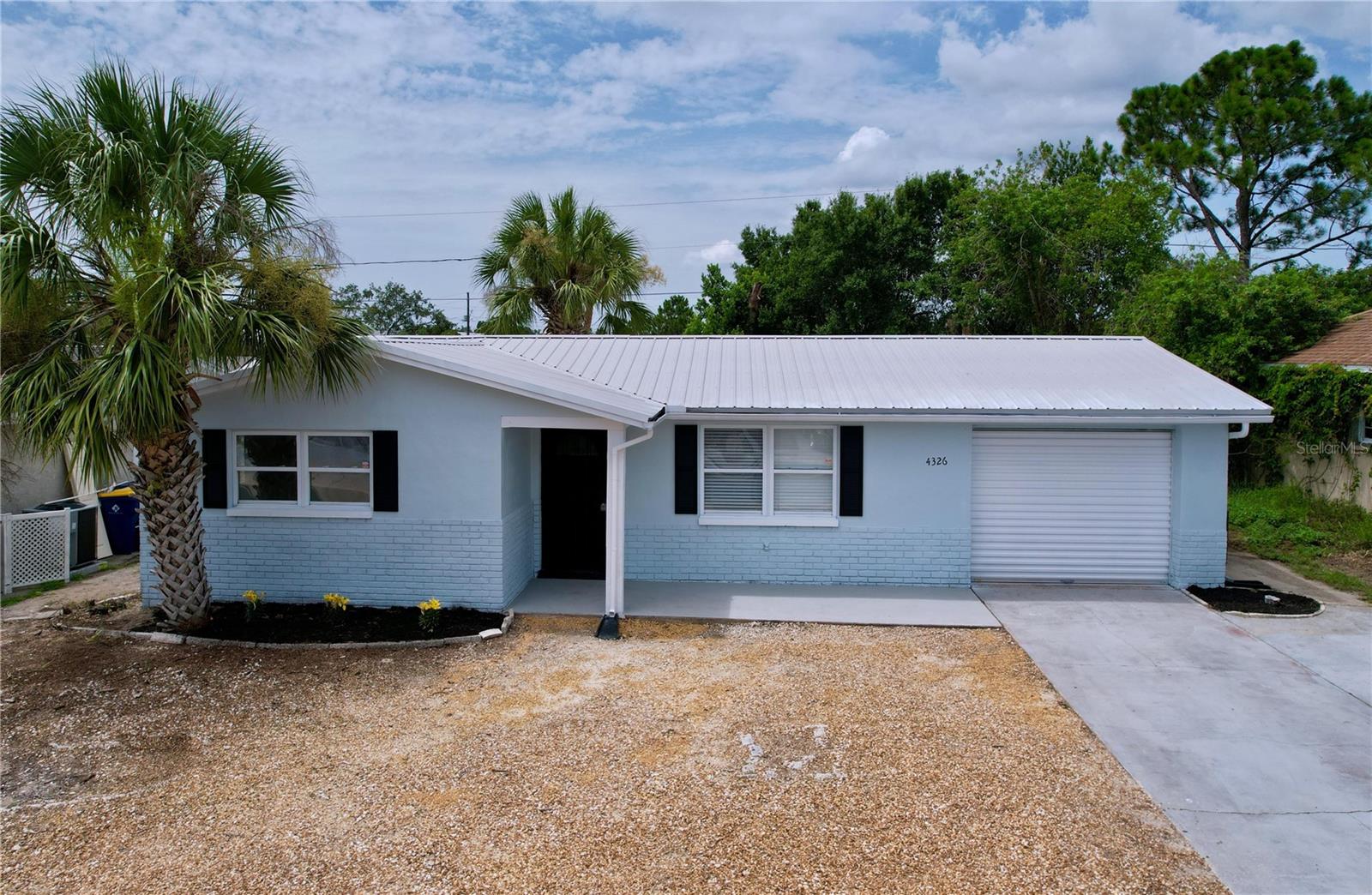 More updates done after listing pictures taken. This renovated, move in ready 3-bedroom, 1-bath home with a 1-car garage, includes a laundry room and a wide driveway. There are no HOA and not located in a flood zone. Renovated throughout, with all popcorn ceiling and carpet removed, new luxury vinyl plank flooring, fresh interior and exterior paint, new lighting and hardware, new quartz countertops, new tub, newer windows, and matching stainless steel appliances. Metal roof is just 5 years old. The layout includes a dedicated laundry room or pet area with space to add a second bathroom. The home includes 2 large bedroom and a third bedroom with a barn door offers flexibility as a den, office, or creative space. Enjoy the outdoors on your patio and a spacious, fully fenced backyard, ideal for pets, relaxation and entertaining. Conveniently located less than a mile from Grocery/Shopping (Publix and Winn-Dixie), and just 7 miles from the beautiful Sunset Beach and Fred Howard Park. Tampa International Airport is only 25 miles away. Set in a quiet sidewalk neighborhook, it's ideal home for downsizers, or small family. Schedule your showing soon!