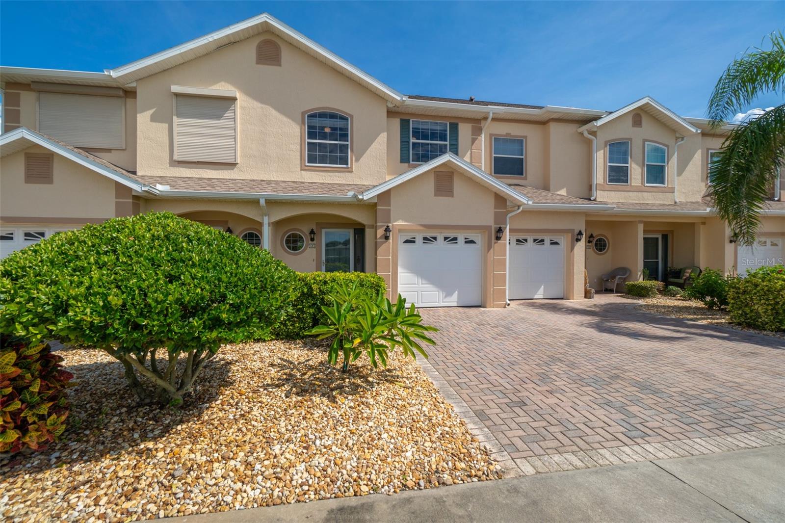 Awesome townhouse across the street from the ocean, this inviting 3-bedroom, 2.5-bath townhome in Villas by the Sea blends comfort and convenience in a beachside setting. Step inside to a sunlit kitchen featuring a new dishwasher, ample cabinetry, and tile flooring, opening to a spacious living and dining area. Glass sliders extend the living space to a private, paved patio, ideal for outdoor dining or lounging. The first floor also offers a half bath, laundry, ample storage, and direct garage entry. Upstairs, the owner's suite features a walk-in closet and an en suite with double vanity, soaking tub, walk-in shower, and private balcony access. Two guest rooms and a full bath complete the second level. Recent updates include fresh paint throughout and a 2023 roof. Tennis court and play park only minutes away, with the Cocoa Beach Pier, shopping, nightlife, and entertainment all within walking distance. Enjoy a low-maintenance lifestyle with the beach practically at your doorstep!