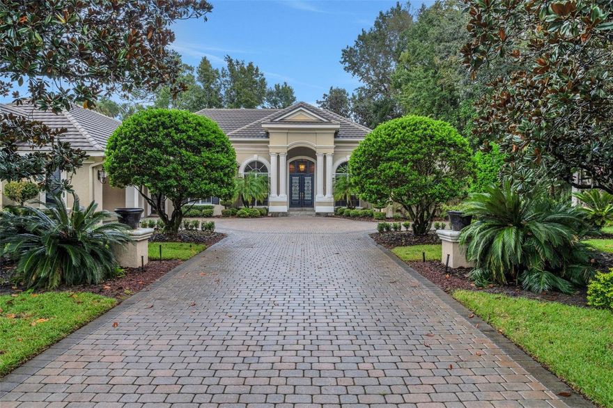 REDUCED FOR A PROMPT SALE!!  Now is your chance to discover this exceptional custom home nestled adjacent to a serene conservation lot in Seminole County’s premier 24-HOUR GUARD-GATED luxury community—Alaqua Lakes. Situated on an OVERSIZED 2/3 of an acre PRIVATE homesite, this residence embodies high-end living in the largest single-story estate residence currently available in the community. Thoughtfully designed and thoroughly updated, this one-story home features soaring 14-foot ceilings upon entry, 4 bedrooms, a dedicated office, a spacious bonus/game room, and 4.5 newly updated baths—offering incredible flexibility for any lifestyle. Step through elegant double glass front doors into a bright, open floor plan with dramatic 14' ceilings and panoramic views of lush landscaping and a sparkling-salt-converted and newly resurfaced pool, all set beneath an expansive covered and screened lanai. Newly installed large-format polished porcelain flooring can be admired in the living room, kitchen, family room, laundry room, and bathrooms, while elegant wood flooring adds a touch of warmth and refinement to the game room and office, and secondary bedrooms.  All living spaces boast impressive 12' ceilings. The recently renovated gourmet kitchen is a chef’s dream, complete with luxurious new countertops, a stylish bar area, and top-of-the-line appliances—including Wolf double ovens, a Wolf induction cooktop, Sub-Zero built-in refrigerator, and Cove dishwasher. Each bedroom boasts its own ensuite, newly updated bath with top-line Kohler products, and oversized walk-in closet, providing comfort and privacy for family and guests. The owner's suite is a private retreat, featuring a generous sitting area, dual walk-in closets, and a spa-inspired bath with a privacy wall for added seclusion. The versatile game room includes a built-in bar, with sink and wine cooler, as well as display case, along with its very own closet; ideal for entertaining friends and family alike! Outdoors, the resurfaced saltwater pool is a true showstopper—perfect for unwinding in your own private oasis. Additional upgrades include newer AC units and water heaters, a replaced outdoor Lynx grill, updated landscaping and outdoor lighting, and more—offering peace of mind and modern efficiency. As a resident of Alaqua Lakes, you'll have access to a unique 7-acre community park with an open-air pavilion, multipurpose field, tennis courts, and more—all just minutes from top-rated schools, upscale shopping, dining, business centers, and major highways. This property may be under audio/visual surveillance.