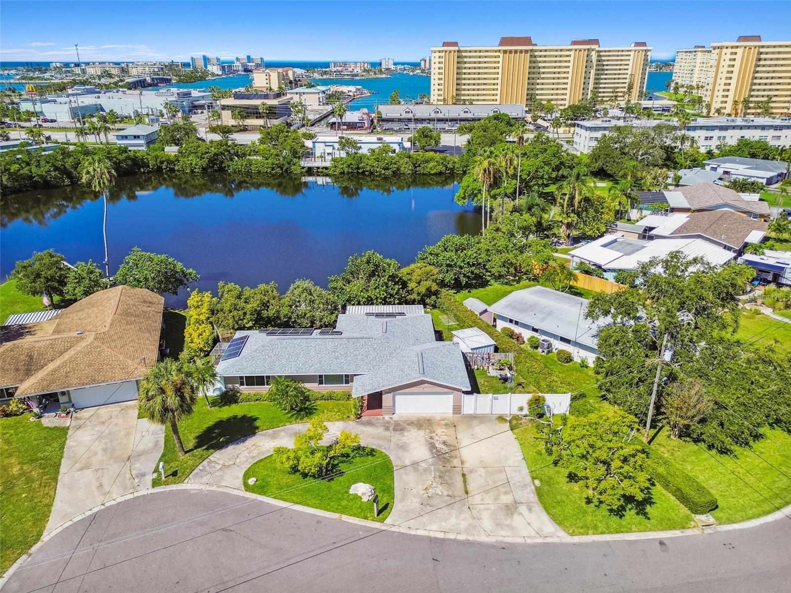 Spend your early mornings fishing for goliath grouper, snook, and more off the dock in your own backyard. Days can be enjoyed at nearby Madeira and Redington Beaches, or take a short drive to downtown St. Petersburg. Make sure to reserve your evenings for those gorgeous sunsets from your tranquil, private backyard! This beautiful home has it all! New kitchen includes soft-close shaker cabinets & drawers, stainless appliances, and quartz counters- and a view to the water. Solar panels help keep energy costs low. The A/C was replaced in 2024, the roof in 2020. Beautiful tile flooring flows seamlessly throughout the home. The main bath has an updated tub surround and quartz counter. French doors out to your private backyard. Spacious bedrooms. The primary bedroom has french doors and an en-suite bath. Motorized roller-shade in family room. Hurricane shutters. Oversized 2-car garage. No HOA. Located in unincorporated St. Petersburg- check out short term rental opportunities! Close to shopping, restaurants, medical. This isn't just a home- it's a must-see private oasis!