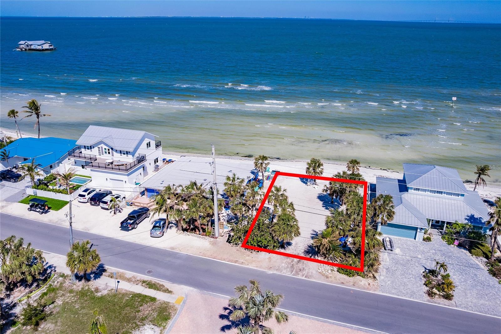 This is your rare opportunity to own a stunning bayfront property with 60 feet of prime bay frontage, perfect for building your custom dream home! This expansive 135-foot deep lot offers unmatched location potential just 5 parcels down from the City Pier. Step out of your door onto your very own private sandy beach, with stunning water views and the iconic Sunshine Skyway bridge lighting up your evenings. Imagine relaxing on a rooftop deck, soaking in breathtaking panoramic vistas of the island. Located just a short walk to Pine Ave shopping or fine dining, including the highly acclaimed Waterfront Restaurant, this is the ultimate in island living. The property is fully prepared for construction with survey, soil borings, and environmental reports already completed. Don’t let this once-in-a-lifetime opportunity slip away—live the island lifestyle you’ve always dreamed of!