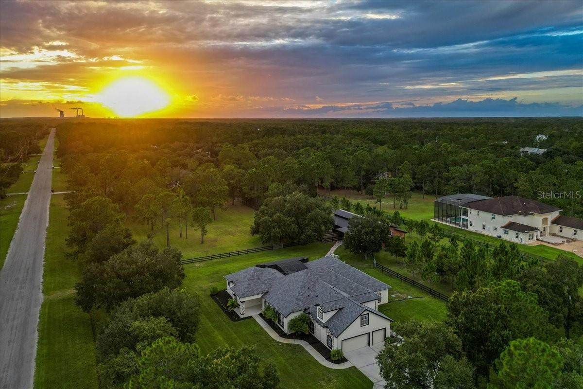 One or more photo(s) has been virtually staged. Luxury Courtyard Estate with Guest Home & Barn on 4.34 Acres!
Extensively updated, this stunning 6-bedroom, 3.5-bath estate features two homes separated by a heated pool courtyard, all on 4.34 fully fenced acres. The main residence offers four bedrooms on the first floor, including a luxurious primary suite with pool access. This retreat offers Hunter motorized shades, and a spa-style bathroom with slate tile flooring, free-standing tub, ribbon-tiled shower, dual vanities, heated mirrors, and a custom walk-in closet.
A versatile upstairs bonus room serves as a 5th bedroom, while oversized secondary bedrooms with walk-in closets provide plenty of space. The chef’s kitchen showcases new wood cabinets with soft-close features, a massive quartz island, and a large walk-in pantry, overlooking the breakfast nook and expansive living room with 8’ sliding glass doors that frame panoramic estate views.
The guest home, across the lanai, is 650 sq. ft. and includes a full kitchen, living room, spacious bedroom with walk-in closet, and bathroom. The courtyard pool area offers water features, new no-see-um screening, and a pre-installed gas line for a future outdoor kitchen.
Equestrian enthusiasts will love the 3,300 sq. ft. barn built in 2021 with three stalls, lighted paddocks, an air-conditioned tack room, wash rack, round pen, and 5 irrigated pastures, including a round pen. A separate 27'x46' insulated garage with AC is ideal for a workshop, RV, boat, or car collection. Recent updates include newer roofs (2023), AC units (2021), water heaters (2024), pool lights (2024), water treatment system (2025), well pump, septic system (2024), automatic gate arms (2025), interior paint, floors, kitchen (2025), pool screen (2025) full-yard irrigation, and more!
Located in a sought-after equestrian and golf community, this property offers access to parks, trails, and A-rated schools, just 30 minutes from beaches, theme parks, and all that Central Florida has to offer.