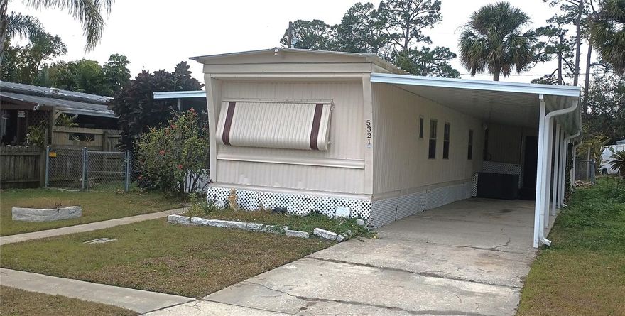 No age restrictions. You own the lot. No fees.  Clean 2 bedroom, 1.5 bath home. Split bedrooms, open kitchen & living room. Seller replaced the sub floors and installed new carpet in bedrooms and new laminate in the kitchen and living room in 2025. Large screened porch(9x30)  with view of the lake across the street. Enjoy the breezes. Fenced yard and storage shed. Carport has ramp to enter the side door. Another shed for storage and laundry. New carport installed 2023. Roof coating 2025. Seller states A/C and water heater are approx 4-5 yrs. Available now for move in. Financing available from 21St Mortgage Corp.