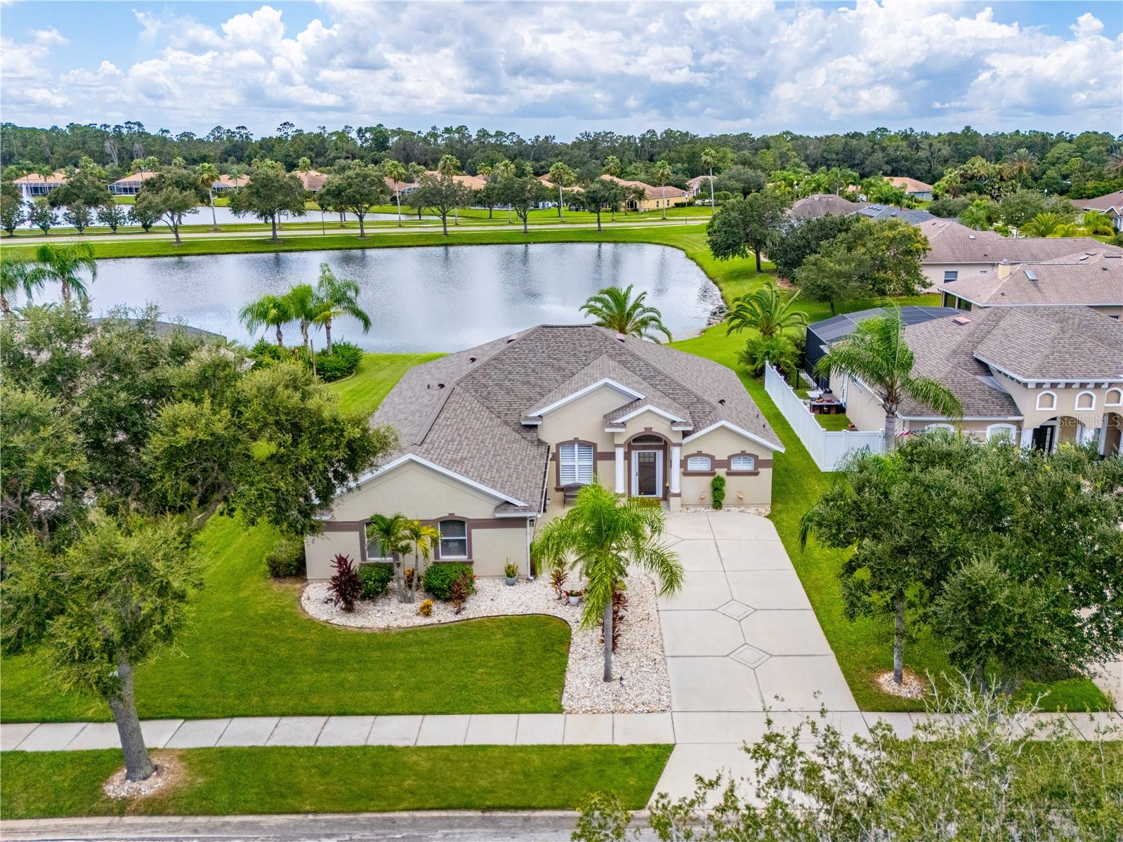 Indulge in the epitome of luxury living with this pristine waterfront residence nestled in the coveted Marisol enclave of the Venetian Bay community. Revel in the exclusivity of a serene cul-de-sac setting. As you approach the home, you are greeted by its stunning curb appeal, highlighted by a side entry two-car garage and charming plantation shutters. Upon entry, the meticulously updated interior captivates with custom drapes, modern fixtures, ceiling fans, and recessed lights that illuminate each space with a warm and inviting glow. Culinary experiences await in the gourmet kitchen, boasting rich wood cabinets with convenient pull-outs, chic tile backsplash, and gleaming stainless steel range hood and appliances. The stone counters and pendant-lit seating area set the stage for intimate meals or entertaining guests, while the infinity window adorned with Hunter Douglas shades offers a panoramic view of the tranquil water beyond.
The primary suite is a sanctuary of luxury, complete with a sitting room and sliders opening to a impact glass-enclosed sunroom (updated in 2022), where the beauty of waterfront living can be savored watching different birds, ducks and beautiful sunsets. A stylish wood sliding door reveals an en-suite bathroom, featuring a jetted tub, separate shower, dual sink vanity, and a walk-in closet.
Guest accommodations are equally impressive, with a remodeled bathroom showcasing a sleek tile wall, shower, brushed nickel fixtures, and sophisticated lighting. Practicality is not forgotten, with an inside laundry complete with a utility sink.
This exceptional property is more than a home; it's a lifestyle. Venetian Bay offers amenities such as dining, a fitness center, a spa, and a golf course. Located conveniently close to beaches, shopping, entertainment, medical facilities, and the Daytona International Speedway, this is the ultimate luxury retreat for the discerning buyer.
Most furnishings negotiable.
All information is intended to be accurate but cannot be guaranteed.
