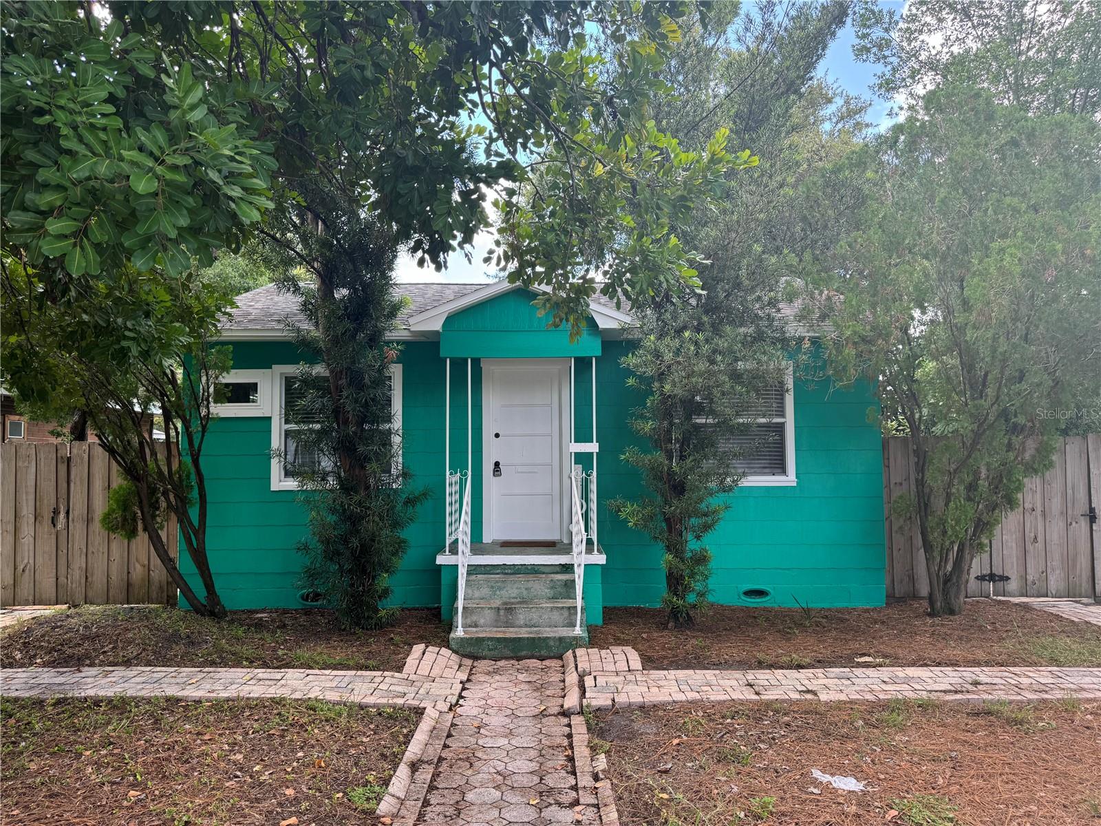 Charming 2 bedroom, 1 bath home centrally located in the heart of St. Petersburg for rent! This delightful home offers fresh paint and a perfect blend of comfort and convenience, ideal for anyone seeking a cozy retreat in a vibrant community. Two great sized bedrooms and an updated bathroom, plus built-ins in the hallway adding to the charm. Enjoy cooking in your generously sized updated kitchen, equipped with ample counter space and storage. The adjacent laundry room adds extra convenience, making chores a breeze. Step outside to a large yard, perfect for outdoor gatherings or simply relaxing under the sun, with additional storage on the other side of the yard. The backyard also features a covered pass-through from the homes back door leading to the 1-car garage, providing protection from the elements and additional storage space. Just a few minutes from Tyrone Mall, St. Petersburg College, and downtown St. Petersburg, making this a wonderful location to call home
