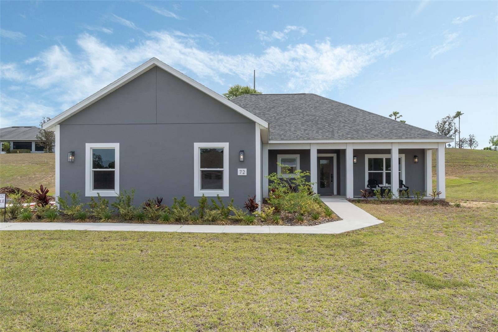 This new-construction 3-bedroom home sits on a coveted corner lot in a gated 55+ community.
The property has fantastic curb appeal, with landscaped garden beds lining the walkway, a side entry garage and a welcoming front porch.
Inside the front door, you’ll find a single-level layout with SCRATCH AND TEAR RESISTANT LVP floors (no carpets here!), custom millwork, modern fixtures and a wall of windows & doors at the rear that fills the entire home with natural light.
The huge kitchen features granite countertops and beautiful Shaker cabinets & drawers that provide so much storage space! The kitchen also offers stainless appliances, a pantry with a large island with provides seating for a crowd. The adjacent open living & dining areas connect directly to the large backyard.
Back inside, the private primary suite occupies its own wing of the home. The bathroom boasts a gorgeous custom-tiled shower and unique his & her vanities packed with storage options. The walk-in closet does triple-duty, also offering a laundry area and direct access to the garage. On the other side of the floorplan, the two guest rooms are separated by the welcoming hallway bathroom with exceptional features.
Twin Lake Estates ia a 55+ community nestled in the rolling hills of North Umatilla. You’ll be close to all the retail shops in downtown Umatilla, with Eustis, Mt. Dora, Leesburg, Ocala & The Villages less than 30-45 mins from your front door. Enjoy the drive to the beach on either coast. Orlando and Disneyworld parks are just about an hour away. You will be impressed by the spacious living areas and upgrades.
Call today to see this one of a kind opportunity.
