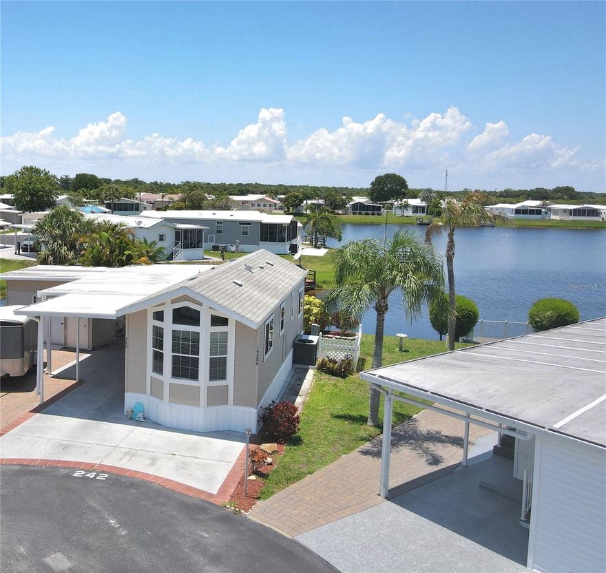 Discover tranquility at this charming one-bedroom, one-bathroom home nestled in the peaceful Blue Cypress Golf and RV Resort, an age-restricted community. Built in 2014, this well-maintained property offers quality construction and modern conveniences with all major appliances included.

Enjoy beautiful water views from the backyard, complete with a private dock perfect for morning coffee or evening sunsets. The community boasts impressive amenities including a golf course, pickleball courts, petanque court, swimming pool, clubhouse, and shuffleboard—offering various recreational opportunities.

The neighborhood provides convenient access to everyday essentials with Publix and Walmart Supercenter just minutes away. For entertainment, the Seminole Brighton Bay Hotel & Casino offers a fun outing option.

Practical benefits include HOA coverage of water, sewer, trash, and lawn maintenance, allowing you more time to enjoy the Florida lifestyle instead of handling chores. Private sewer and water systems ensure reliable utilities year-round.
All measurements are approximate.