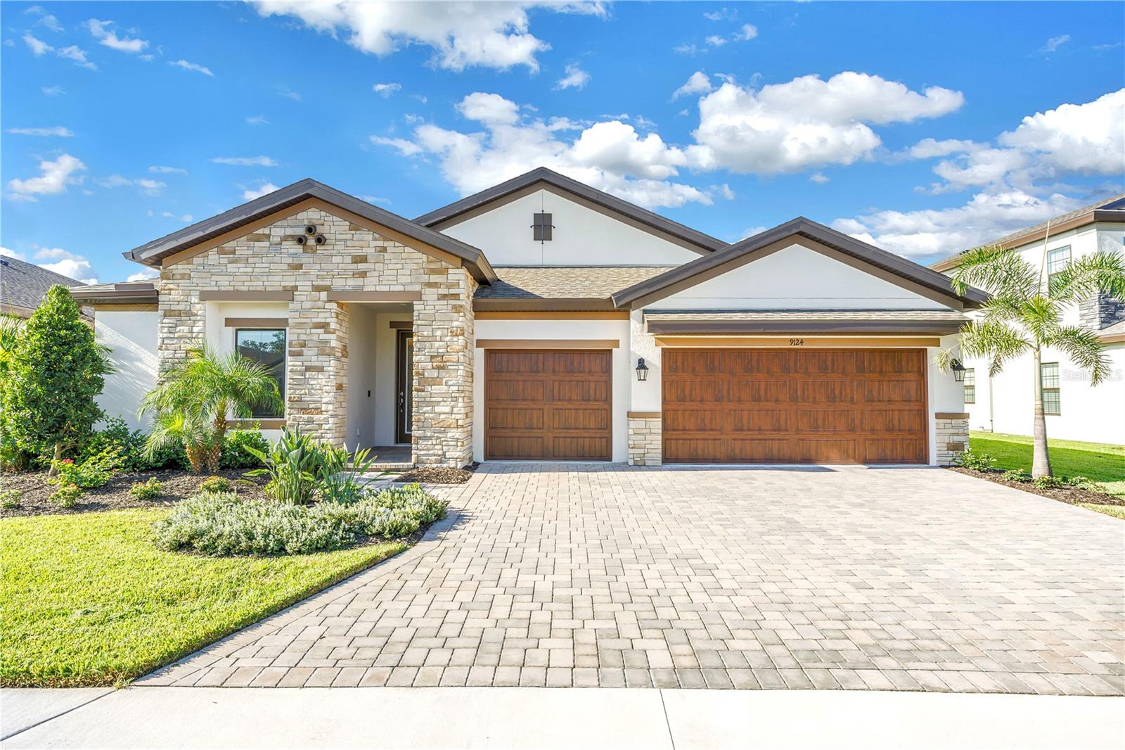Move in ready, highly upgraded and located on a $30,000 south facing premium lot with ample yard space for a pool! Discover the epitome of luxury with the rarely available, Swann III floor plan from Homes By Westbay. This Swann III floor plan maximizes utility boasting a 2,736 square foot, single story layout consisting of 4 bedrooms, an enclosed den with French glass pane doors, 3 full bathrooms and a 3 car garage. The open-concept main living space is filled with natural light with the best views from the 16’ collapsible sliding glass door. Enjoy 11.5’ ceilings throughout the main living areas of the home that highly compliment the open concept floor plan. The kitchen includes quartz counter tops, a tile backsplash, upgraded under cabinet lighting, upgraded GE Profile appliances including a 36” electric cook top and range hood, a GE Cafe refrigerator, a single bowl under mount stainless steel sink and ample storage including cabinets built into both sides of the oversized island. Step into the inviting primary suite overlooking the pond that flows into the large en suite bathroom with double vanities, an oversized walk in shower, upgraded stand alone Kholer tub, upgraded calacatta tile, upgraded front and back lit vanity mirrors and a brand new custom closet and built-in vanity from Closets by Design. The laundry room includes front loading LG washer/dryer and a wall mounted laundry tub. Additional upgrades include Caresoft Pro Whole Home Water Softener System, Minka Aire ceiling fans with remote controls in all rooms, Graber cordless privacy shades throughout home, tray ceilings and crown molding in the primary suite, den and foyer, glass front door, epoxy garage floor, crystal chandelier in foyer, travertine pendant lights above island, upgraded lighting throughout including bathrooms. Situated on the cul-de-sac of all Westbay Homes with minimal through traffic within the Master-planned community of Brightwood at North River Ranch. NRR has 3 resort style pools including the recently opened Canoe Creek which features water slides, a clubhouse, skate and bike park, pickleball courts, game room and walking paths. Brightwood’s prime location places you 30 minutes from St. Petersburg and Sarasota, 40 minutes to downtown Tampa with easy access to I-75, I-275 and US-301. Ensure to watch the virtual tour on YouTube! Schedule your showing to tour this immaculate home today!