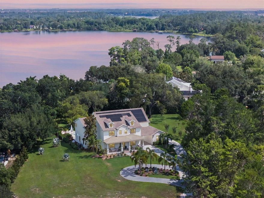 5351 Carson Street | Nearly 5 Acres | Secluded Luxury | Less than 10 minutes to Lake Nona Behind private gates at the end of a wooded cul-de-sac, this 6BR/5.5BA custom estate offers 5,782 sq. ft. of luxury living on nearly 5 acres with serene lake views and built-in quad and hiking trails, all just minutes from everything Lake Nona has to offer.

Completely renovated in 2024 with more than $1M in upgrades, the home features European white oak flooring, designer lighting, and custom millwork. The chef’s kitchen showcases custom in-lay cabinetry, a leathered granite island, venetian plaster hood, hidden walk-in pantry, and high-end appliances including a 43-inch La Cornue induction range, 36-inch Monogram fridge/freezer columns, Fisher and Paykel double drawer dishwasher, ice maker, and multiple beverage centers. Resort-style outdoor living includes a marble pool deck, custom pool and spa with water feature, summer kitchen, outdoor pool bath, new landscaping, and a 1,000-gallon buried propane tank.

The private upstairs primary suite offers a steam shower, freestanding tub, smart toilet, custom closet system, balcony with lake views, and serene surroundings. Secondary suites include a first-floor guest retreat along with oversized upstairs bedrooms featuring en suite and Jack-and-Jill baths. The home also includes a five-car garage with a four-car pass-through and an additional bay ideal for a gym or workshop, two laundry rooms and a custom mudroom, and a bonus room with office and private stair access. Thoughtful details such as whole-home water filtration, two tankless water heaters, two new AC units, solar panels, a 2020 roof, whole-house generator, and walk-in closets throughout complete the offering.

A rare find, private and secluded yet only minutes to Lake Nona, this estate with its sprawling grounds and endless possibilities invites you to create a generational retreat designed for gatherings, memories, and legacy living. Words and photos cannot capture it all, this one must be experienced in person.