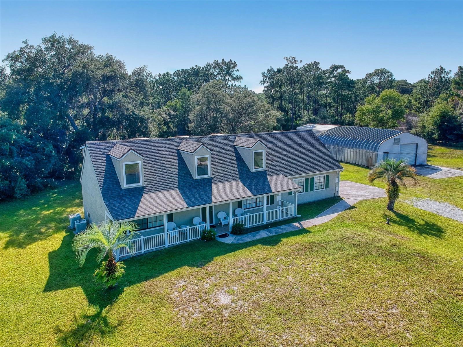 Large, elegant DeLand property offers the rare combination of spaciousness and privacy all within minutes of the main highway and area attractions. Situated on a serene private road, 1524 Rockingham Ln, is a sprawling estate on 2.5 acres of beautifully landscaped land. This fully fenced property boasts a spacious 5-bedroom, 3-bath home, thoughtfully designed for comfort and style. This multi-level home features a huge living room and natural light throughout. The interior is fully furnished, including all appliances, ensuring a move-in-ready experience. The home features an inviting pool area, perfect for relaxation and entertaining. Additionally, multiple outbuildings provide ample storage perfect for ATVs, boats, cars etc. Zoned A-4 transitional agricultural for livestock. This private oasis offers both tranquility and convenience, making it an ideal retreat for its future owners.