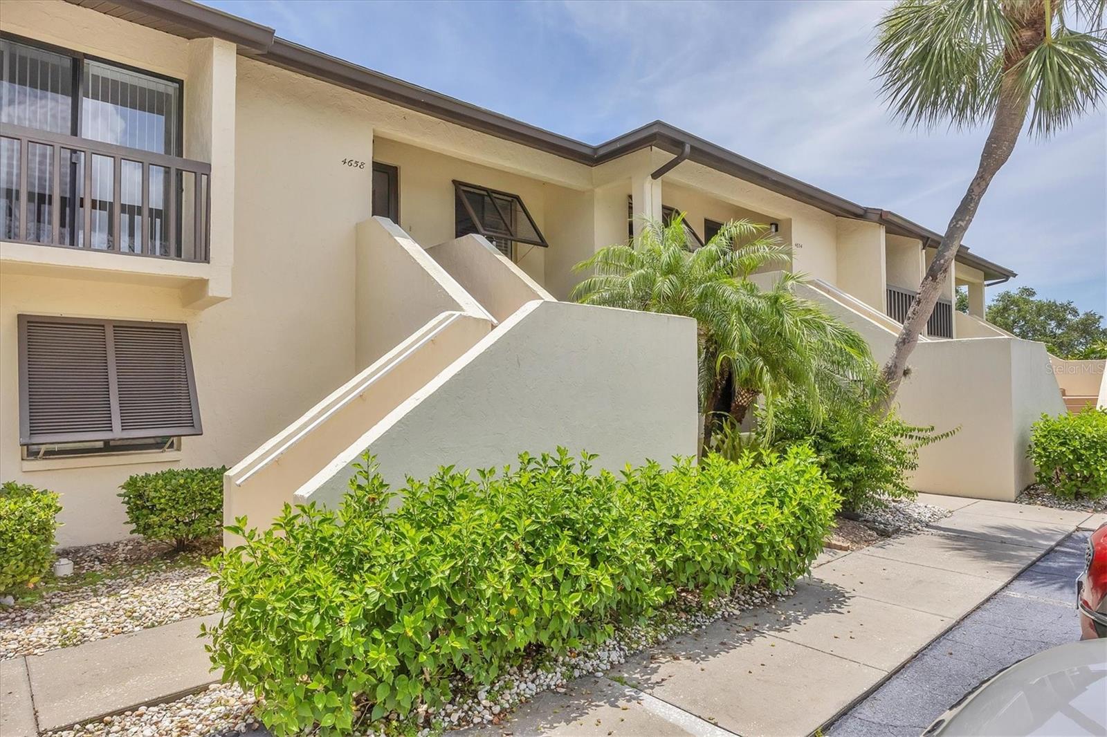 Low-rise condos are in demand, and The Meadows is so convenient to downtown Sarasota. 1600 acres; 14 miles of sidewalks; a 1.7-mile fitness trail; 10 pickle ball courts, active tennis courts and so much more. Turnkey & Move-In Ready! This beautifully updated 2nd-floor condo offers easy maintenance-free living in a vibrant setting. Enjoy a light-filled open floor plan with vinyl plank flooring, an updated kitchen featuring shaker cabinets, granite counters, subway tile backsplash, and stainless appliances. The spacious primary suite offers dual closets, an updated en-suite bath, and sliding doors to a large screened lanai overlooking the residents-only pool at Longwater Chase. The guest bedroom includes its own updated en-suite bath—this entire condo is truly a pleasure to be in and if peace and quiet is what you seek - here it is. One might also consider the potential rental income if an investment is on your mind. Extras include in-unit laundry with storage and a stackable washer/dryer. Longwater Chase is pet-friendly with two pools and green space to enjoy. Low HOA fees, one-month minimum rentals, and a fantastic location close to University Town Center, Benderson Park, and just 20 minutes to the beaches. There is good reason to check it out!