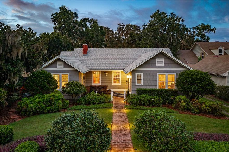 A TRUE Mount Dora Classic on the Shores of Spring-Fed Lake Gertrude!
This beautifully maintained home captures the timeless charm and craftsmanship of a bygone era, thoughtfully remodeled to perfection for modern living. Set on a lush, private ½-acre lot with approximately 80 feet of direct lake frontage, this property offers stunning views and an unmatched lakeside lifestyle.
Shaded by century-old oaks, the backyard is a true tropical paradise leading to a privately landscaped beach,  deck, and cabana complete with water and electric — the ultimate setting for lakeside entertaining.
The welcoming front entry opens to historic character and warmth, featuring restored original heart pine floors, custom millwork, and abundant natural light. The updated kitchen boasts handcrafted cabinetry, quartz and butcher block countertops, stainless steel appliances, built-in oven and microwave, and a spacious center island with bar seating.
The main floor offers four spacious bedrooms, one-and-a-half baths, and open, light-filled living spaces with vaulted wood-beam ceilings, custom wrought-iron railings, built-ins, and a cozy wood-burning fireplace. The dining and family rooms open to the lakeside deck and patio overlooking lush gardens and breathtaking lake views.
The lower level features a luxurious primary suite retreat with a private outdoor entrance, huge custom walk-in closet, and a newly added ensuite bathroom with double sinks, soaking tub, and large walk-in shower. The unique full basement offers endless possibilities — ideal for a media room, recreation space, or home gym.
Additional features include a heated and cooled one-car garage, lake-fed irrigation system, 2019 hot water heater, 2013 roof, and septic system pumped and inspected in October 2025. A recent 4-point inspection is available upon request.
Enjoy all that coveted Lake Gertrude has to offer — from paddleboarding, skiing, and fishing to peaceful sunrise or sunset boat rides on its crystal-clear waters, or leisurely walks along the scenic promenade. Ideally located just minutes from Mount Dora’s vibrant downtown, with its charming shops, fine dining, art galleries, parks, and year-round festivals — easily reached by stroll, bike, or golf cart. Experience the best of Mount Dora living in this rare Lake Gertrude gem — where timeless elegance meets lakeside luxury.
