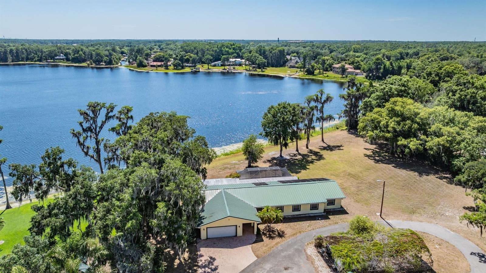 Discover the unparalleled potential of this substantial property at 215 Lake Brant Dr. Situated in a serene, picturesque neighborhood, this expansive lot boasts over 4 acres of land and 295 feet of stunning lake frontage, offering a unique canvas for your dream home or an investment opportunity. Whether you're envisioning a sprawling estate or looking to maximize returns by splitting the lot and building two stunning homes, this property combines the tranquility of suburban living with the convenience of urban amenities. This property sits on a ski-sized lake, Lake Brant, which covers over 60 acres and provides direct sunset views. Enjoy easy access to top-rated schools, fine dining, and shopping centers, all while being close to major highways for quick commutes to Tampa. Embrace the lush natural surroundings and mature trees that frame this beautiful property, located in a friendly community just north of Avila Golf and Country Club. The growing demand for housing in Lutz makes this property a smart investment, providing both a serene retreat and connectivity to the vibrant life of the Tampa Bay area. Don't miss this rare chance to own prime real estate in Lutz—contact us today to explore the potential of 215 Lake Brant Dr.