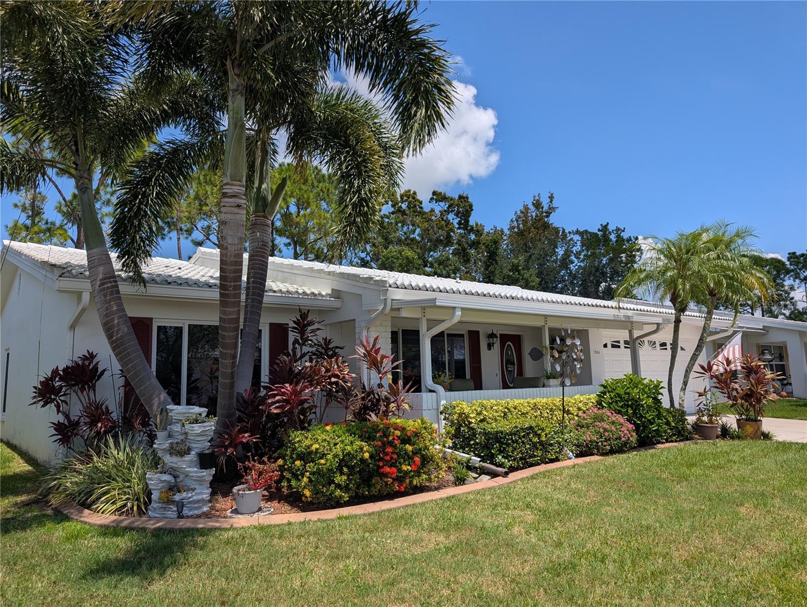 "WOW" a phenomenal "Gormay" with a great location!! Clubhouse is a stone throw away, the golf course is just a chip & putt away. This pristine 2BR/2BA/2CG open concept home showcases "Pride of Ownership" inside & out. Visitors are welcomed by a well-manicured mix of tropical/rustic landscaping accented w/cement curbing (2021). Attention to detail continues to the interior…this home won’t disappoint! Interior features include soft soothing décor, blonde engineered hardwood flooring, custom Hunter Douglass Silhouette window treatments, 4" baseboard trim, crown molding, newer ceiling fans/lighting w/remotes as well as beautifully updated kitchen & baths. Living/Dining/Florida & Sunroom all surround the "Heart of the Home"... the kitchen. This gorgeous kitchen features numerous updates: granite countertops, glass tile back splash, custom Maple cabinets w/matte black hardware, stainless steel appliances (WP refrigerator w/ice maker (2020), GE Monogram dishwasher, GE glass cooktop (2021), GE built in wall oven & GE microwave hood (2019)), an exquisite matte black custom faucet, undermount stainless steel sink, disposal, undermount cabinet lighting (no dome) & built-in desk/office area w/window installed for extra light. Impressive Sunroom features a stunning bifold glass door & direct access to the awesome back lanai (2018) w/custom Gemstone Diamond coated floor (2021) & back open patio (great spot for grilling). A wonderful space to relax & enjoy Florida outdoor living. A stunning stone electric fireplace is focal point of Florida room which also offers 3" faux wood blinds & a pass thru window to kitchen...a great feature when entertaining. Dining room is centrally located off kitchen between the Living & Florida room. Both spacious bedrooms feature walk-in California style closets, ceiling fans w/lights & blonde hardwood floors. Renovated bathrooms include: granite countertops, maple vanities, comfort height commodes, porcelain tile floors, hardware, mirrors & lighting. Master ensuite bath offers beautifully tiled walk-in shower. Guest bath offers an updated tiled backsplash bathtub/shower area. Exterior features include: pavered (2021) pet friendly fenced (2019) front porch w/composite roof (15), 7" gutters w/Leaf Guards (2019), tinted (2019) heavy duty double pane windows (2000), tile roof (2002), French drain (2019) & keyless entry. Garage offers: 3-ton, 15-seer Trane HVAC (2018), 200-amp Eaton electrical panel (2018), AO Smith 40-gal water heater (2013), pull down attic access, workspace/custom built in storage, Genie door opener, Clopay garage door & exterior side door. Laundry, also located in garage, offers WP washer/dryer set & utility sink. Unit 5 welcomes 2 pets! Monthly maintenance fee of $342.89 includes lawn care/irrigation maintenance, exterior painting/power washing, water/sewer/trash, internet/cable in addition to maintaining all community property (clubhouse, pool, roads, sidewalks, lakes)! Mainlands of Tamarac by the Gulf Unit #5 is very active, 55+ community offering a clubhouse, heated in-ground pool, shuffleboard courts, public golf course & many other activities. A Tropical Paradise located in the "Heart of Tampa Bay" centrally situated between St. Petersburg, Clearwater & Tampa. Additional conveniences include lots of nearby shopping, sporting/cultural venues, excellent medical/emergency care facilities, restaurants, banking, churches as well as easy access to Gulf coast beaches, US-19, I-275 & two airports.