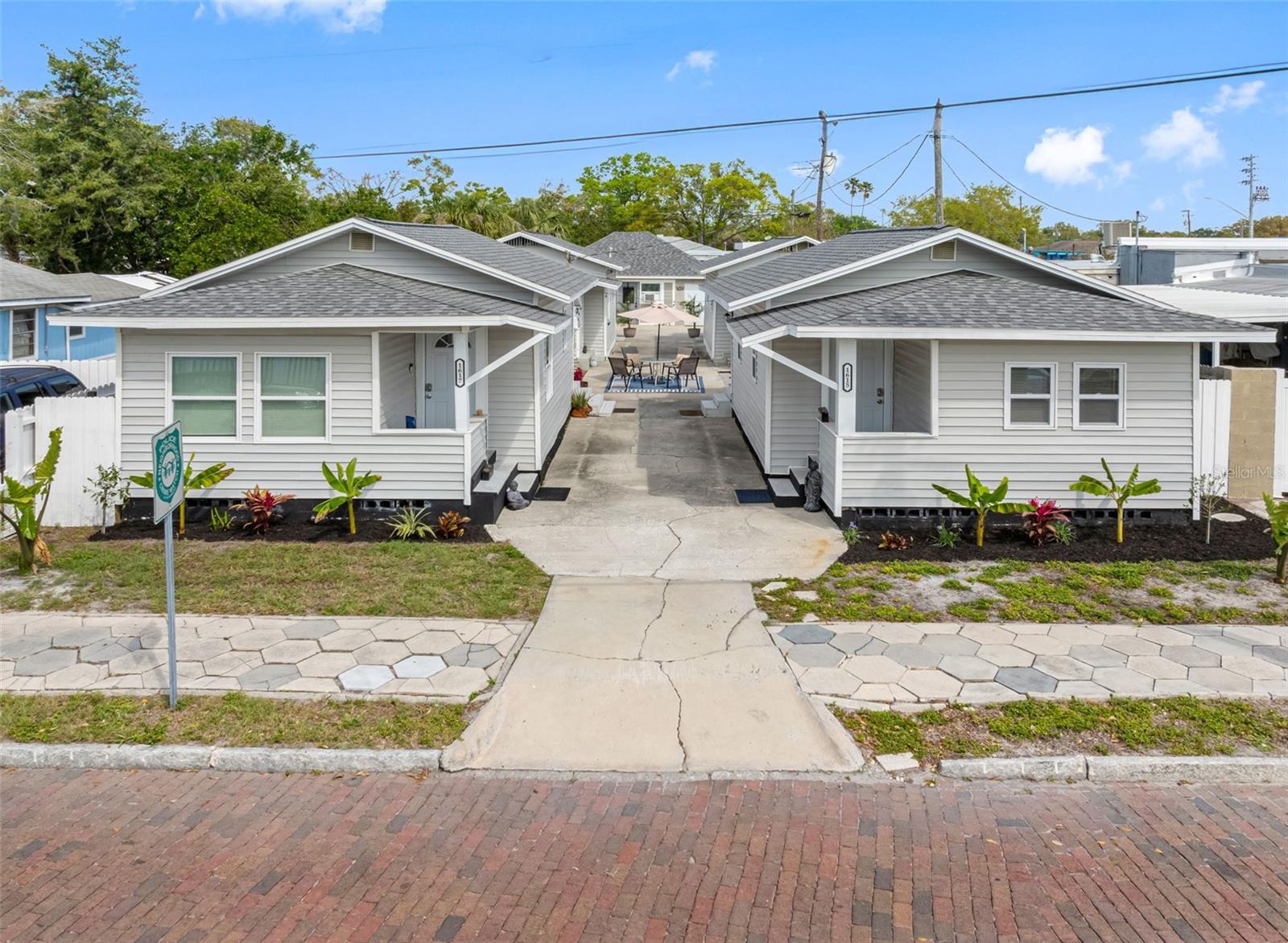 OFFERED BELOW RECENT APPRAISAL — Meticulously renovated from top to bottom, this multi-unit gem in the heart of St. Pete is truly turn-key. Every inch has been thoughtfully upgraded — from new roofs, windows, plumbing, and electrical to all-new modern finishes, landscaping, and hardscaping. TOO MANY IMPROVEMENTS TO LIST — ASK FOR THE FULL SCOPE OF WORK AND PERMITS, ALL CLOSED.
Set on a wide corner lot along St. Pete’s iconic red brick roads, this fully stabilized compound includes four 1-bed, 1-bath residences — each with a flexible bonus room perfect for an office or guest space — and a detached garage-turned-lounge or optional on-site manager’s suite. Zoned for 30-day minimum rentals but ideal for long-term tenants, every unit is separately metered and fully furnished with kitchenware, linens, and décor, making it truly plug-and-play.
Extensive improvements include new roofs on all 5 structures (2022), new vinyl siding, impact-rated windows and doors, updated HVAC systems, new electrical panels and wiring, new plumbing supply and drain lines, and energy-efficient water heaters. Interiors feature granite countertops, modern cabinetry, luxury vinyl plank flooring, updated fixtures, and recessed lighting.
The property also includes a standalone commercial-grade laundry building with brand-new coin-operated appliances, providing added convenience and additional income potential. The central courtyard is a showstopper — with café string lighting, new pavers, tropical landscaping, and curated gathering areas that create a boutique hotel-style atmosphere. Select units even feature custom murals that add charm and a touch of art-forward identity.
Located just minutes to Crescent Lake, downtown St. Petersburg, The Pier, Tropicana Field, Gulf beaches, and I-275 — and only 20 minutes from Tampa International — this is a rare chance to own a cash-flow-ready, personality-driven investment in a high-demand rental corridor.
