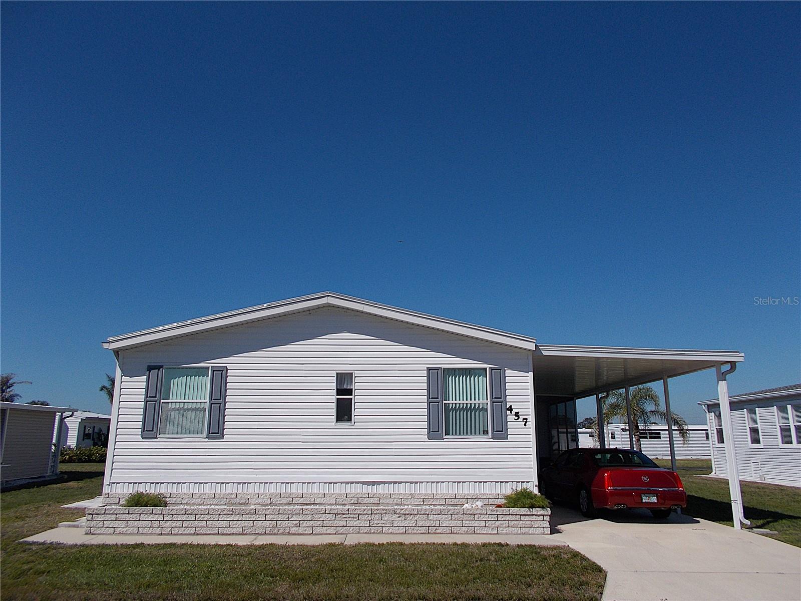 Welcome to your beautiful home located in sought after Sandalwood Park! This 2 bedroom + den, 2 bath, 2004 built double-wide manufactured home has so much to offer!! Large room sizes, open split-bedroom floor plan, eating area in the kitchen, dishwasher AND inside laundry are just the start. The primary bedroom has an ensuite bathroom with 2 vanities, walk-in shower AND 2 walk-in closets! Home offers a newer roof, a/c, ductwork and hot water heater. Don't you just love spending time out on the lanai? This home has a lovely sitting area off the kitchen with a great view of all the greenspace behind you and a larger version to enjoy the fresh air and comfortable evenings. Being that your laundry is located inside, your 10x8 shed can all be used for "shed stuff." And the icing on the cake? This home is being sold turn-key furnished!! Just bring your suitcase & toothbrush and welcome home! Sandalwood Park recently amended it's pet policy so there's no more weight limit for 2 of your furry family members and they have installed a dog park too! Tons of activities to enjoy and the location of the park is fabulous! Come take a look today and make this beautiful home yours. . . . . before someone else does!