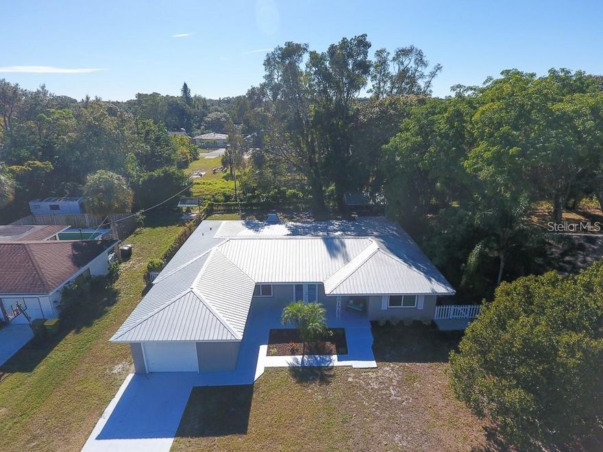 Welcome to the HEART of Sarasota! This property is located a HALF a mile from the World Renowned Sarasota Memorial Hospital, a half mile to the Hillview Restaurant District, under 1 mile to the Siesta Key Bridge, less than 2 miles to Downtown Sarasota, and a very SHORT WALK to South Side Elementary School!!! This 2300 sq ft home has been remodeled from top to bottom! The updates include: Metal Roof, Top of the Line PGT Hurricane Impact Windows, New Plumbing, New Flooring, and freshly painted. The interior of the house features: Granite Counter tops, Stainless Steel Appliances, wood burning fire place with a warm travertine stone wall. The 4th bedroom is extremely spacious, has an inviting bay window, and also makes for a great den. Enjoy your relaxing back yard which has mature landscaping, a brick paver patio, and a gazebo / putting green!