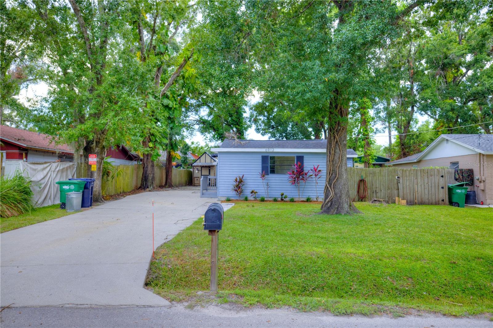 This cozy 3 Bed 2 bath house is tucked away in the Lowry Park (zoo) area just north of Seminole Heights. A deep lot with mature lush shade trees, private driveway, and front and back yards. Upgraded where it matters, the home has a modern kitchen with granite counters, modern appliances and fixtures. The bathrooms are similarly upgraded with granite vanities, tile and upgraded fixtures. Laminate wood plank style flooring in the main living areas, with carpet in the bedrooms. Tub/shower combo in the guest bath and stall shower with glass partition in the master. The master also has a back door for direct back deck and yard access. Off the living room and master, there are large stacked front load washing machines in a utility closet. 2019 roof. The long driveway has ample parking and there's a back deck large back yard for outside enjoyment, and shed for optional storage. This neighborhood is minutes away from and convenient to downtown, healthcare facilities including St. Joseph Main, Armature Works, Riverwalk, Seminole Heights dining and I-275. Ready to move in, as-is sale.