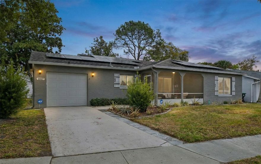 Solar Savings, Easy Living & an Unbeatable Location in Lake Ridge Village!

Welcome home to this beautifully maintained solar-powered gem in sought-after Lake Ridge Village, located in the desirable Williamsburg area of Orlando. With the solar system fully paid off at closing, you’ll enjoy energy savings for years to come — combining efficiency, comfort, and smart homeownership all in one.

This charming two-bedroom, two-bath home offers bright, open living spaces designed for both everyday living and effortless entertaining. The spacious living room flows seamlessly into a formal dining area, creating the perfect setting for hosting family and friends. Luxury vinyl flooring runs throughout the home — completely carpet-free for easy maintenance and modern appeal.

The kitchen features granite countertops, stainless steel appliances, and a convenient breakfast bar, making it both functional and inviting. The primary suite is a true retreat, offering dual sinks and an upgraded walk-in shower. The secondary bathroom has also been beautifully updated, providing comfort and style for guests or family.

One of the standout features of this home is the incredible outdoor living space. The extended covered lanai is equipped with vinyl windows that can be closed during rainy days or opened to invite in a wonderful Florida breeze. The front porch is screened as well, giving you even more space to relax and enjoy the outdoors year-round.

The one-car garage adds convenience, while the HOA takes care of lawn maintenance, making everyday living even easier.

Residents of Lake Ridge Village enjoy access to community amenities including a clubhouse with activity room, library, billiards room, community pool, and tennis courts — offering a vibrant and active lifestyle.

Location truly sets this home apart. Just minutes from SeaWorld, International Drive, The Premium Outlets, The Loop, and The Florida Mall, with quick access to I-4, 528, 417, Central Florida Parkway, John Young Parkway, and Orlando International Airport, you’re perfectly positioned for work, travel, dining, and entertainment.

Solar savings. Easy living. Incredible location.
This one is ready for you — come see it today.