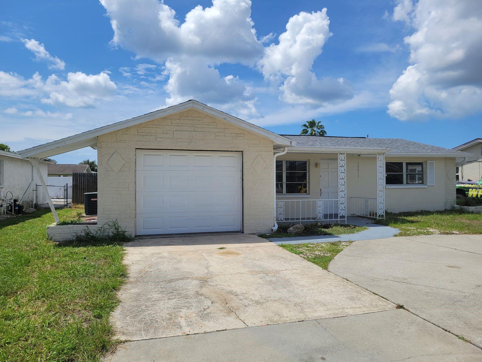 Welcome to your dream home in Port Richey - a beautifully renovated three-bedroom, two-bath property featuring modern comfort and charming aesthetics. As you enter, you will be welcomed into an extra-large, wide-open living room/dining room space with large windows letting all the natural light in. The like-new kitchen is a cook's delight, furnished with attractive granite countertops, solid wood cabinets and a complete appliance package. Both bathrooms have been tastefully overhauled to feature contemporary fixtures and finishes. Throughout the home, you'll find new flooring and a freshly painted interior, setting a tone of timeless elegance and warmth. The home also features a screened lanai perfect for outdoor leisure, as well as a privacy fenced backyard - an ideal setting for all your entertaining needs. There is also an one car garage perfect for storage with washer/dryer hook-ups. Nestled perfectly to ensure convenience, you'll be within close proximity to a league of shopping outlets and restaurants, making this home both a comforting sanctuary and a hub for easy living. Contact us right away to schedule your tour!