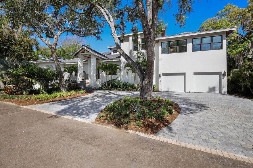 One or more photo(s) has been virtually staged. NOTE: 14' elevation on first living level, AC units at 14.2' elevation, set up for generator, garages dry, no flooding in Debby, Helene nor Milton! No damage to home either. This home is a fortress built to exceed building standards.

Step into the realm of unparalleled luxury within this meticulously crafted new construction home, the crown jewel of a gated community strategically positioned for the utmost convenience and exclusivity. Located in close proximity to downtown Sarasota's vibrant amenities, including restaurants, theaters, and boutiques, this residence offers not only a home but a lifestyle of unparalleled sophistication. 
Proudly bearing the distinction of being the builder's own residence, every facet of this home reflects a commitment to excellence, with each detail meticulously considered and executed to perfection. What truly distinguishes this property is its unparalleled access to two of Sarasota's breathtaking bayfront parks: The Bay, heralded as the city's most dynamic public bayfront park, and Whitaker Gateway Park, a mere stone's throw away. Moreover, residents are privileged to enjoy sunsets from the community day dock where you tie up your vessel for the day or enjoy the hues of dusk as they paint the sky in a breathtaking display of natural beauty. In addition to its enviable location and amenities, this home boasts tremendous value in its features, including five bedrooms, a shimmering pool, rejuvenating spa, and an expansive media/game room primed for entertainment. With a four-car garage, complete with a designated space for toys, this residence seamlessly blends functionality with opulence, catering to the most discerning homeowners. Discover the epitome of craftsmanship and design, where urban sophistication harmonizes with waterfront tranquility. Indulge in the perfect synthesis of modern luxury and coastal allure, as you embrace a lifestyle of unparalleled refinement in this extraordinary residence.