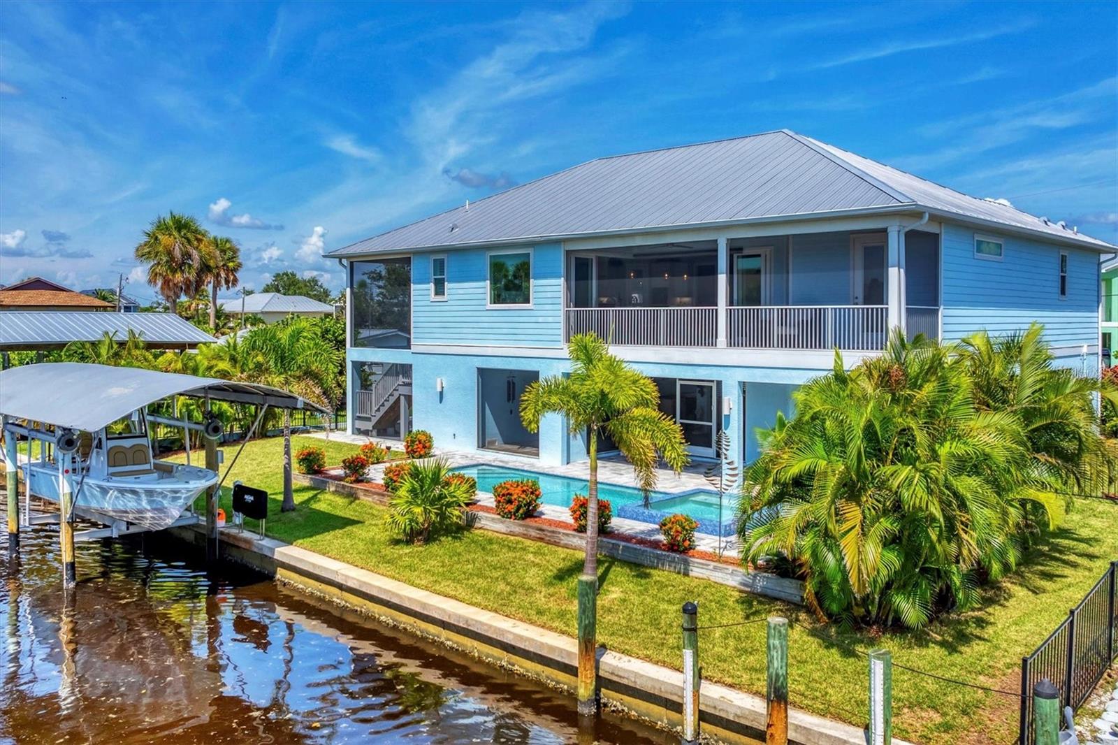 Living the LUXURY LIFESTYLE on the Intracoastal Waterway & Lemon Bay is ONE home away from
reality! By water, the deep canal with NO BRIDGES is a boater’s dream come true! You are minutes from
STUMP Pass & the Gulf or motor South to Boca Grande & Charlotte Harbor. Prefer to hang local? Enjoy the
beautiful sandbars and miles of beach in Englewood. Welcome to 10476 Sherman Street situated in Palm
Harbor with no HOA fees or restrictions! This magnificent elevated 2020 custom built home features state-of-the-art design & intricate details. A complete property feature list is available on request. To peek your interest, here are a few top reasons to
book a flight or plan a road trip to personally view this home: Move in immediately or promote
this popular vacation destination on AIBNB. Walking distance to the Cape Haze Marina and Freedom Boat Club IMPACT windows and doors * METAL ROOF * Cement FiberSiding * Covered BOAT LIFT * 93 Ft of SEAWALL * 1,200 lb. capacity CARGO LIFT * SALTWATER &
HEATED POOL with Zero Edge / Perimeter Overflow SPA * Amazing screened entertainment sitting and
outdoor kitchen space at pool level * Elevated screen porch deck overlooking pool and canal facing the Western
Sunsets * 90 degree ZERO Corner SLIDERS * Coffered vaulted ceilings * Plantation Shutters * Sonos Sound
System *Granite from Brazil kitchen counter tops * Built-in double over and stove top * Granite dual vanities in primary
suite * ROMAN walkthrough shower with stained glass accent wall * Private Guest Suite stairway and entrance
*split bedroom floorplan*** This impeccable home feels and looks brand new. The owners reside periodically
and did not rent the home out to vacationers. The outdoor screen space underneath this elevated home is a
versatile multi-purpose open air living area protected from sun and rain. The unique layout feels like part of
your living space. The garage is separated by a wall and entrance door so you do no feel like you are
entertaining or relaxing in your garage. Coastal living at its finest! Do not hesitate on this one, call for your
private showing today.