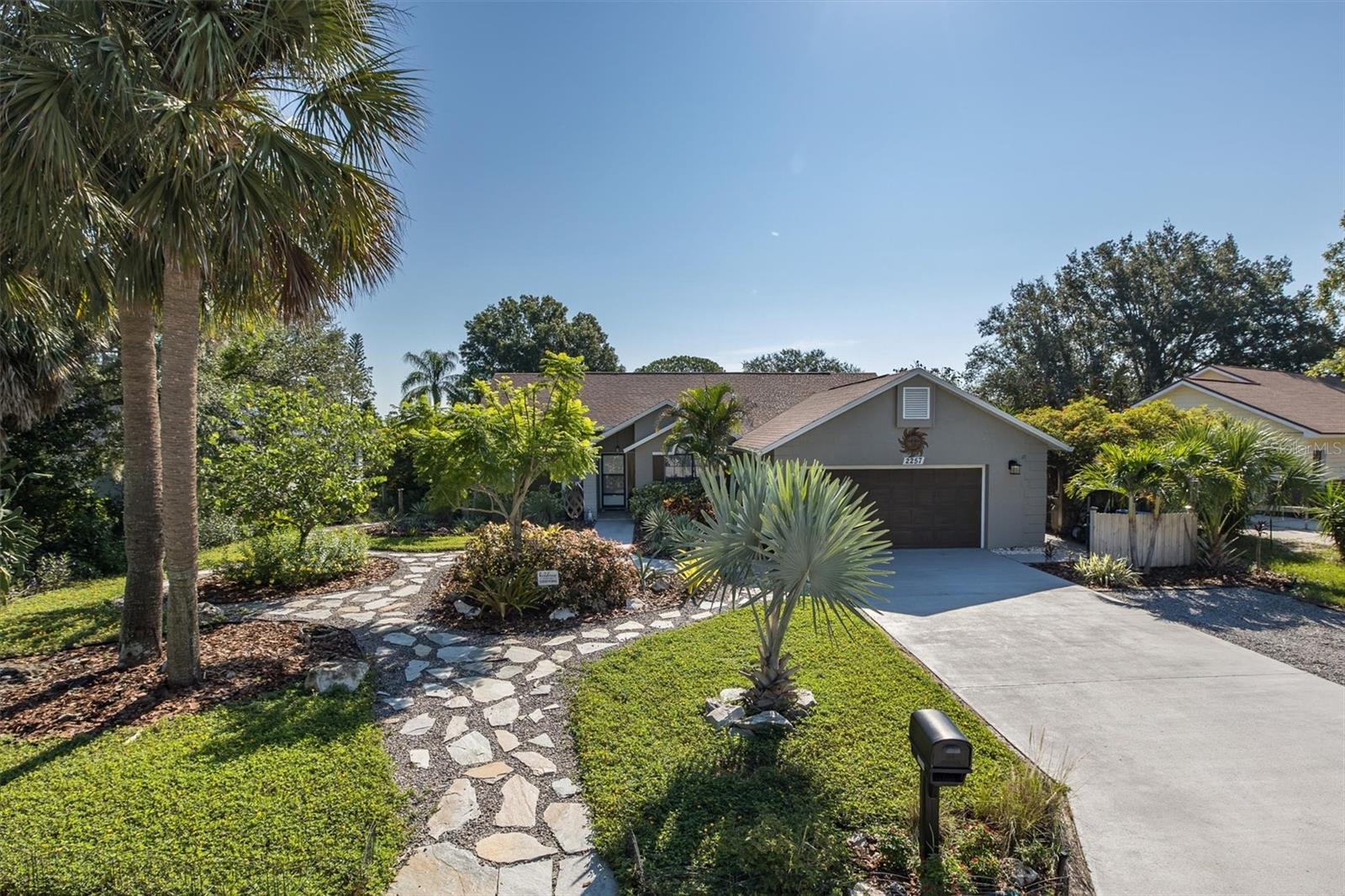 Under contract-accepting backup offers. Welcome to your entertainer’s dream home—a stunning 3-bedroom, 2-bath, 2-car garage oasis perfectly positioned on a unique oversized lot along the breathtaking Gulf of America. This one-of-a-kind property offers an unparalleled blend of resort-style amenities, natural Florida beauty, and a sense of peace and privacy that is simply unmatched. Step outside into your own private paradise, where beautifully landscaped, Florida-friendly gardens surround you with vibrant color and lush greenery. Designed for low maintenance and equipped with automatic watering, the grounds provide year-round natural beauty with minimal effort. At the heart of the backyard, the solar-heated pool sparkles under the Florida sun, inviting you to relax, entertain, and enjoy the ultimate in outdoor living. This backyard sanctuary has been thoughtfully designed to create an experience, not just a space. A charming outdoor gym offers a place to focus on your wellness, while a dedicated gardening area allows you to indulge your green thumb. For moments of peace and reflection, a tranquil meditation and yoga cathedral awaits, surrounded by tropical landscaping. Golf enthusiasts can enjoy a private driving area, and evenings come alive around the cozy firepit lounge with ample seating. A self-replenishing saltwater tidal pool adds a magical touch, attracting fish during the tides and connecting you to the surrounding natural beauty. From hammocks gently swaying in the breeze to spaces for cornhole, bocce ball, and a flourishing herb garden, every detail has been thoughtfully crafted to create your own personal resort. Inside, the home is equally captivating. The soaring cathedral ceilings in the living room create an airy, open ambiance, while large sliding glass doors invite endless views of the pool and gardens, seamlessly blending indoor and outdoor living. The split-bedroom floor plan offers privacy, with the primary suite tucked away as a true retreat. Enjoy a spa-like ensuite bathroom featuring a custom live-edge vanity, a generous walk-in closet, and sliding doors that open directly to the pool and gardens. The stylish kitchen boasts a custom live-edge peninsula, contemporary tile, and ample storage, flowing effortlessly into the dining area for easy entertaining. Throughout the home, newer flooring, fresh paint, and upgraded baseboards combine to create a polished, move-in-ready space. There is even a custom office conversion within the garage, offering flexibility to work from home or easily restore it for parking if desired. Best of all, this property offers peace of mind with no flood insurance required and no flooding during recent storms. No HOA or CDD! Imagine launching your kayak from your backyard and gliding through the mangrove-lined waterways out to Sand Bay and beyond to the Gulf. Every day feels like a vacation in this extraordinary home. This is more than a home—it’s a lifestyle, a retreat, and a personal sanctuary along the Gulf of America. The Anclote Trail that connects to the Pinellas Trial is right the around block for walking and biking. Don’t miss the chance to experience this exceptional property. Call your real estate professional today to schedule a private showing.