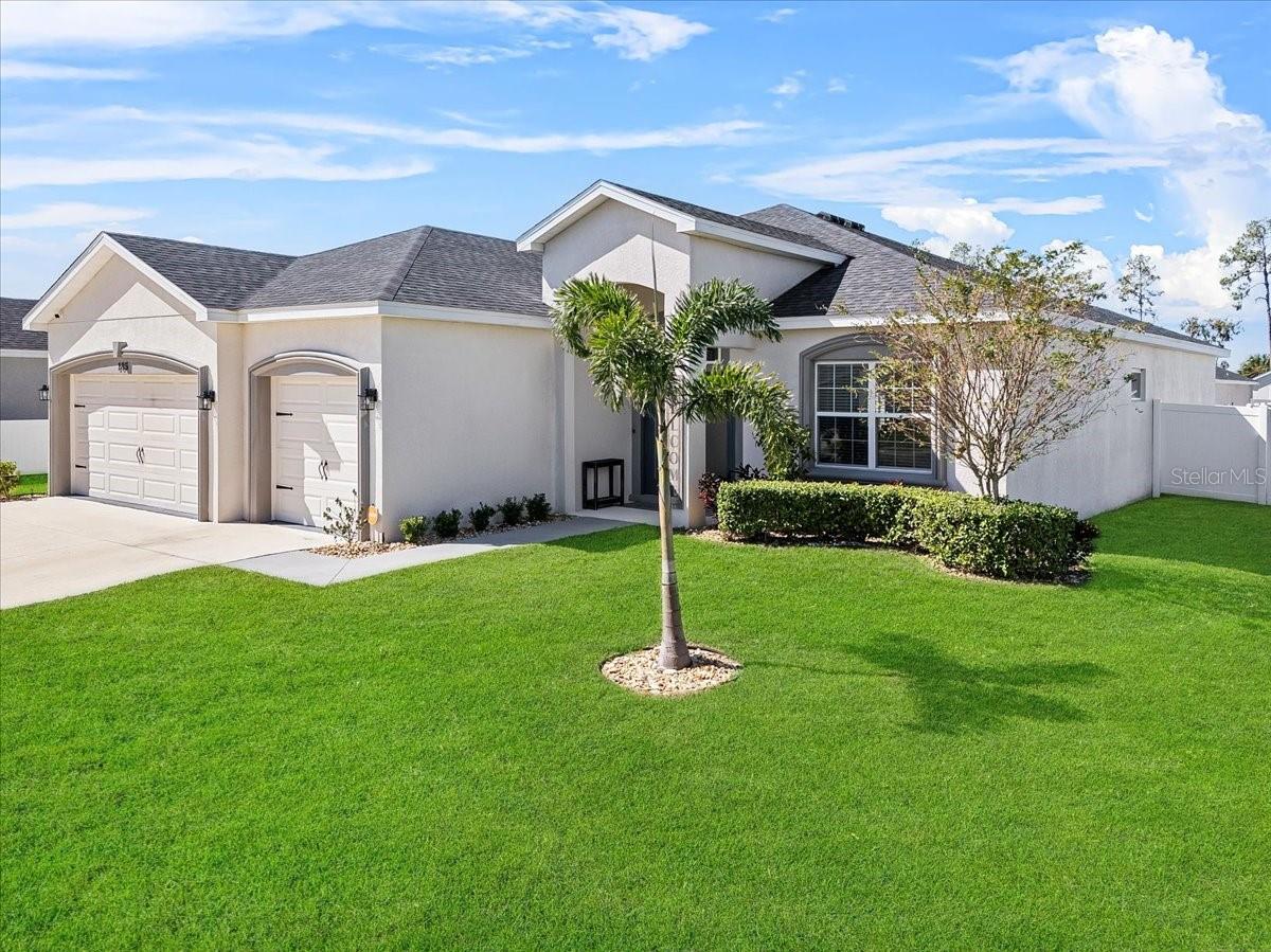 One or more photo(s) has been virtually staged. Stunning Upgraded Home on an Oversized Corner Lot. This home is a beautifully upgraded and meticulously maintained home nestled on a premium corner lot in the highly desirable Bridgeport Lakes community. With striking curb appeal, lush landscaping, and an interior that blends modern luxury with everyday functionality, this property is the perfect place to call home. This home features 4 bedrooms and 3 bathrooms. The primary suite has a spa-like en-suite bathroom. There is also a 2-bedroom suite with a bath and a 4th bedroom and a guest bath. When entering the home, you step through elegant double-fronted doors with rain glass into a bright, open-concept layout filled with natural light. A versatile flex space to the right makes the perfect home office, reading nook, or creative studio, while a formal dining room to the left sets the stage for memorable family meals and entertaining. At the heart of the home is a chef-inspired kitchen featuring state-of-the-art Samsung BESPOKE appliances, including an induction range with built-in air fryer and a sleek glass-panel refrigerator with a beverage center. Solid wood cabinetry and stylish bullnose countertops provide both beauty and functionality, flowing seamlessly into the spacious living area. The living room features a room-darkening pleated shade on the slider for enhanced privacy and energy efficiency. Enjoy brand-new luxury vinyl plank flooring throughout, paired with upgraded 5½-inch baseboards for a clean, polished finish. The expansive primary suite is your private retreat, complete with tray ceilings, recessed lighting, and a large custom-designed walk-in closet with movable shelves and rods created by Cabinets by Design. The spa-like en-suite bathroom offers a dual-sink vanity, oversized walk-in shower, and a luxurious garden tub. The home offers a second primary suite on the opposite side of the home—perfect for guests or multi-generational living—features its own private entrance, en-suite bath, and a custom closet with barn doors and high-end closets by Closets by Design. Additional highlights include: All fixtures, lighting, and hardware have been updated to reflect today’s design trends. Generously sized guest bedroom. A stylish and functional laundry room with custom cabinetry and top-of-the-line LG front-load washer and dryer. Screened lanai overlooking a fully fenced backyard with single and double gate access. Programmable outdoor lighting and a full irrigation system covering the front, side, and rear yards and emitter sprinklers for the front and back flower beds. Don’t miss your chance to own this exceptional home in one of Mulberry’s most sought-after communities.