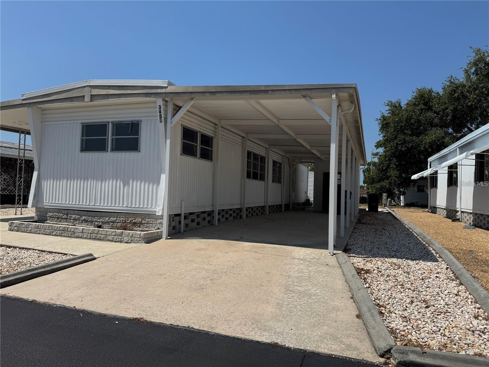 55+ mobile home Park gated community of Tiki Village. HOA is only about $35.00 per month, no CDD. Move in ready for modern style living with 2-Bedrooms, 2 full bathrooms.! This fully updated home is designed with comfort and, convenience, master bath has a full-size tub for relaxation. Enjoy high-end finishes like brand-new stainless-steel appliances, granite countertops, and a sleek tankless water heater. The split-plan layout includes two ensuites, ensuring privacy and functionality. Durable vinyl plank flooring adds sophistication, while the car park and separate storage shed with washer and dryer hookups provide ultimate convenience. Community perks include shuffleboard, a spacious picnic pavilion, and a beautiful Veterans Memorial display at the entrance, offering a warm welcome home. Close proximity to Tampa, famous Sponge Docks with authentic Greek food, boat ride to see the manatees, shopping, outlet mall, dining and more. Call for your private showing and to make offer on this one of a kind opportunity.