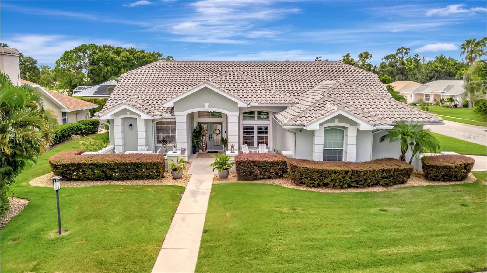 Stunning Coastal-Designed Pool Home on Large Corner Lot in Misty Oaks. This pristine home radiates curb appeal with a beautifully manicured yard, lush tropical landscaping, and a welcoming double door entry. Situated on a desirable corner lot, this home features extra yard space and a classic tile roof that enhances its architectural charm. Inside, enjoy a bright and open split floor plan with vaulted ceilings and pocket sliders that seamlessly connect the main living areas to your private outdoor retreat. The gracious living room flows effortlessly into a large formal dining room—perfect for entertaining, while the charming breakfast nook overlooks the sparkling pool, offering a peaceful spot for everyday meals. The center of the home, the coastal-inspired kitchen, features solid wood cabinetry with beautiful moldings, quartz countertops, stainless-steel appliances, an induction cooktop, and a built-in microwave. Step outside to the expansive lanai, finished with travertine pavers and surrounded by lush tropical landscaping, where a heated and cooled pool provides year-round enjoyment in total privacy.
The private primary suite offers direct lanai access, a walk-in closet, and a fully renovated spa-style bathroom featuring dual vanities, a spacious walk-in shower, a garden tub, and elegant designer tile and lighting throughout. Two generously sized guest bedrooms, one with access to the pool area, are located on the opposite side of the home, along with a beautifully appointed guest bathroom featuring dual sinks—ideal for family or visitors. Additional features include an oversized garage, a well-equipped laundry room with ample cabinetry, counter space, utility sink, clothes drying rack, and built-in ironing board. Energy efficiency shines with a 1-year-new 24 SEER ultra high-efficiency A/C system, Kevlar storm screens, and newer windows and sliders throughout, including an Impact slider and garage door for peace of mind. With a low HOA and no CDD fees, this impeccably maintained home offers luxury, comfort, and exceptional value in the exclusive Misty Oaks community—an intimate neighborhood of just 63 homes. Enjoy a quiet, private setting without sacrificing convenience, as you're ideally positioned near Sarasota’s best shopping and dining destinations. From upscale restaurants and shops to scenic parks, nature trails, golfing and the pristine Gulf Coast beaches just minutes away, this home delivers the perfect blend of lifestyle, location, and ease.