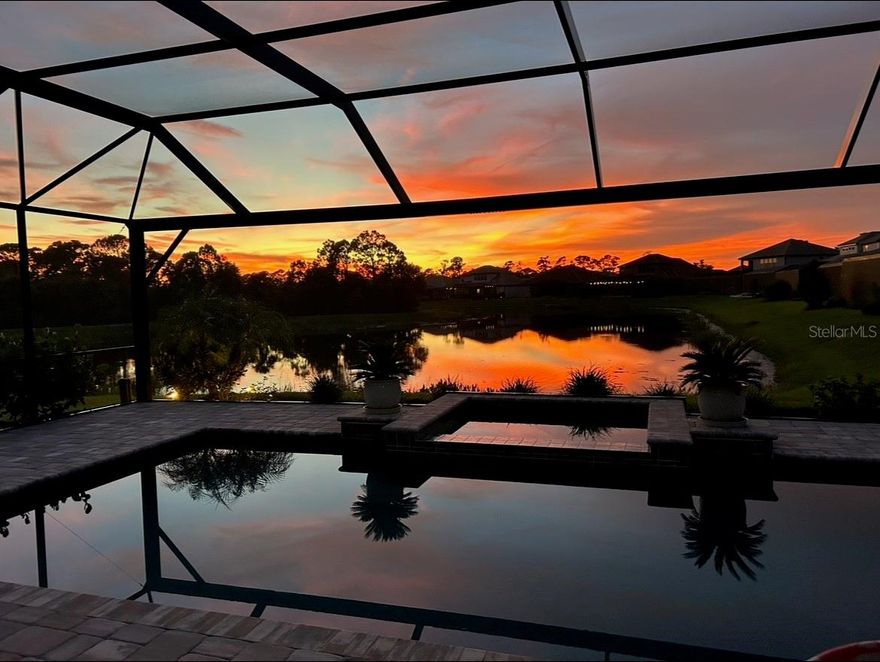 Waterfront Pool Home in Oasis at Wellen Park! Enjoy 2,805 sq. ft. of luxury living in this stunning waterfront pool home located in the gated community of Oasis! Featuring 4 bedrooms plus a study/den and 3½ baths, this home is ideal for both a retired couple seeking space and comfort or a growing family ready to entertain. The spacious kitchen offers a large island with quartz countertops, a farmhouse sink, and upgraded stainless appliances. Details include tile flooring throughout the main living areas, tray ceilings and crown molding. The split floor plan provides privacy, with guest bedrooms set apart from the spacious master suite. The open-concept living and dining areas highlight picturesque lake views, enhanced by a wall of impact-resistant sliding glass doors leading to an expanded paver pool deck with a portrait screen for unobstructed long lake views. Relax outdoors with a heated pool and spa, and a large covered sitting area—perfect for entertaining, grilling and quiet evenings. Additional upgrades include plantation shutters, garage racks for additional storage, privacy landscaping around pool cage and upgraded tile and glass enclosed showers. Residents of Oasis enjoy access to a community pool, pickleball court, and clubhouse. Conveniently located near the Atlanta Braves’ spring training facility, golf courses, beaches, shopping and restaurants. This home offers the ultimate in Florida living.