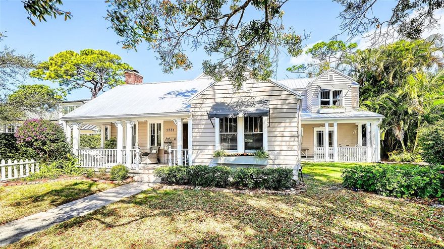 In the "heart" of the most popular West of Trail neighborhood, step into a rare piece of Sarasota history just a short stroll  to Southside Village restaurants and shops, downtown and 2 blocks to Sarasota Memorial Hospital. Behind a classic white picket fence, this 1926 home welcomes you with a generous yard framed by mature landscaping and colorful gardens. A cozy front porch sets the tone for your entrance into timeless architectural details which blend seamlessly with modern updates. Wood floors run throughout the living areas with natural light pouring in through numerous windows. Tall ceilings are complimented by original wood trim. All the details we love in an older home yet with many updates. The main home offers 2,575 sq ft thoughtfully laid out for everyday living and entertaining. The main level features multiple living spaces, separate dining room, a guest bedroom, a dedicated office and laundry room. Upstairs, the spacious owner's suite plus  an additional bedroom with ensuite bathroom provide comfort and privacy. The remodeled kitchen is beautifully appointed with granite counters and custom cabinetry AND....a charming 306 sf studio-style guest cottage that has its own entrance and patio. COME SEE THIS BEAUTY, you will LOVE it.