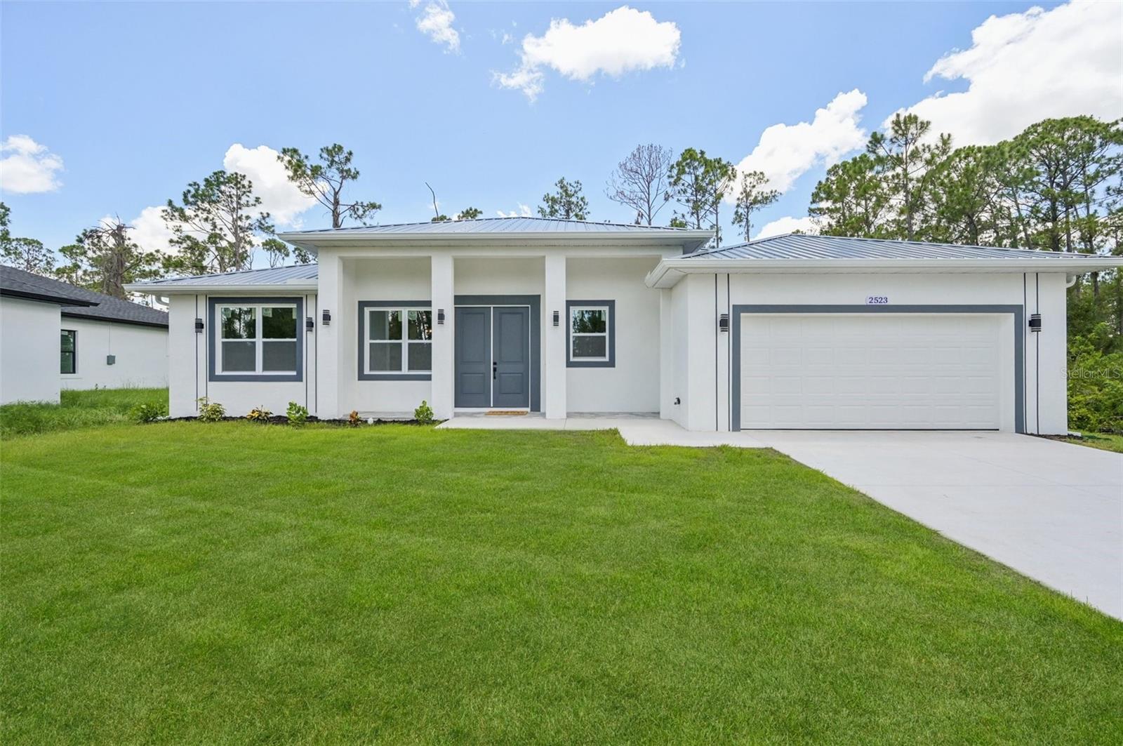 This beautifully designed Move In Ready 3-bedroom, 2-bathroom concrete block home with a 2-car garage sits on an extended lot along a serene freshwater canal—perfect for kayaking, fishing, and enjoying peaceful water views with NO FLOOD zone. Built for durability and efficiency, the home features a metal roof, impact-rated windows, doors, and garage door, and is proudly Florida Green Building Coalition Gold Certified, offering energy savings and reduced insurance costs. Inside, you'll find an open floorplan with 10-foot ceilings, 8-foot doors, and tile flooring throughout. The kitchen boasts solid wood soft-close cabinets, granite countertops, modern hardware, and LED lighting for both style and efficiency. Backed by a builder warranty, this home delivers lasting value, comfort, and quality. Available now!