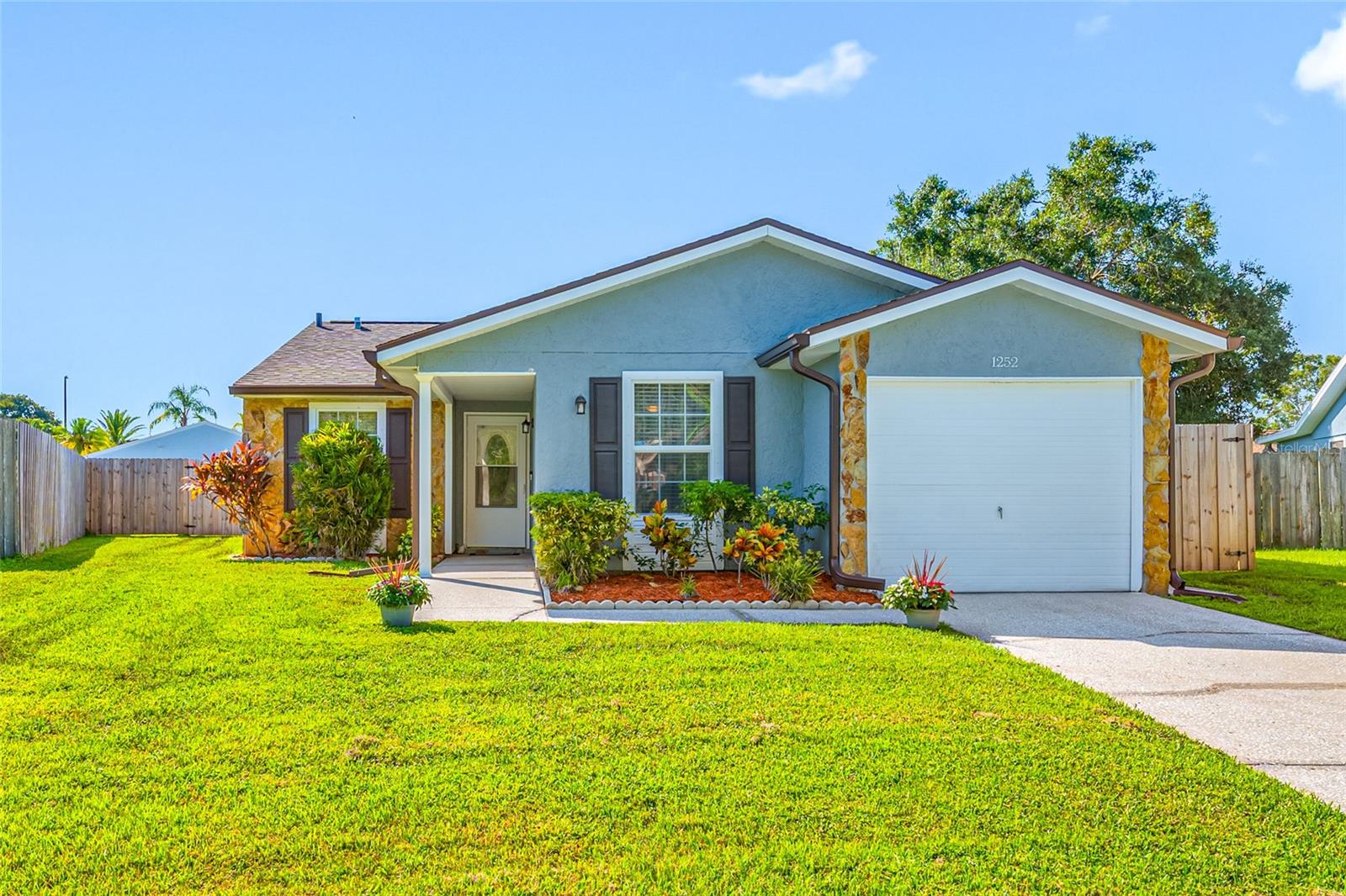 Beautifully updated 3-Bedroom, 2 bath home with a 1 car garage, in the desirable Forest Lakes Community in Oldsmar! This lovely home is situated on a peaceful cul-de-sac in an ideal location. As soon as you enter the home, you will feel welcomed by the charming entry, with the open floor plan, vaulted ceilings and elegant porcelain tile, which sets the stage for modern living. Great floor plan seamlessly connects the kitchen and dining area to the spacious living room, complete with a cozy electric fireplace and sliding doors out to the newly screened in patio. The kitchen is updated, offering stunning quartz countertops, a chic glass backsplash, updated cabinetry, newer stainless-steel appliances, and a convenient quartz breakfast bar to chat with the cook. Soft-close and pull out drawers along with a pantry cabinet enhance both functionality and style. The dining room is just off the kitchen, for your convenience and ease in serving that special dinner. Retreat to the primary bedroom, where comfort meets luxury—complete with a ceiling fan and an en-suite bathroom featuring new tile, fixtures, and an LED mirror with a stylish vanity. Bedrooms two and three include laminate wood-look flooring and built-in closets. A newly updated second bathroom features new decorative tile around the tub and a new modern vanity. The laundry room offers convenience with a newer washer and dryer and additional storage cabinets. Recent upgrades include a newer air conditioning system (2022), a brand new roof (2025) with a 25 yr transferable warranty, and newly installed gutters (2025). Step outside to your own private oasis with an over-sized fully fenced yard, and screened in patio with new wide panoramic screens, and tile flooring. Additional features include hurricane wood panels for added safety, a one-car garage with storage cabinets, and a security alarm system for all windows and doors. Enjoy exceptional community amenities for just $35/month, including a pool, fishing pier, tennis, basketball, handball courts, a playground, and picnic areas. Conveniently located near shopping, dining, and entertainment in Oldsmar. You know what they say: location, location location! Easy access to both sides of the bay, and within minutes to both Tampa and Clearwater/St Pete airports! This charming home offers a perfect blend of comfort, modern updates, and community living. Come and see what a great place this would be to call home! Schedule a viewing today!