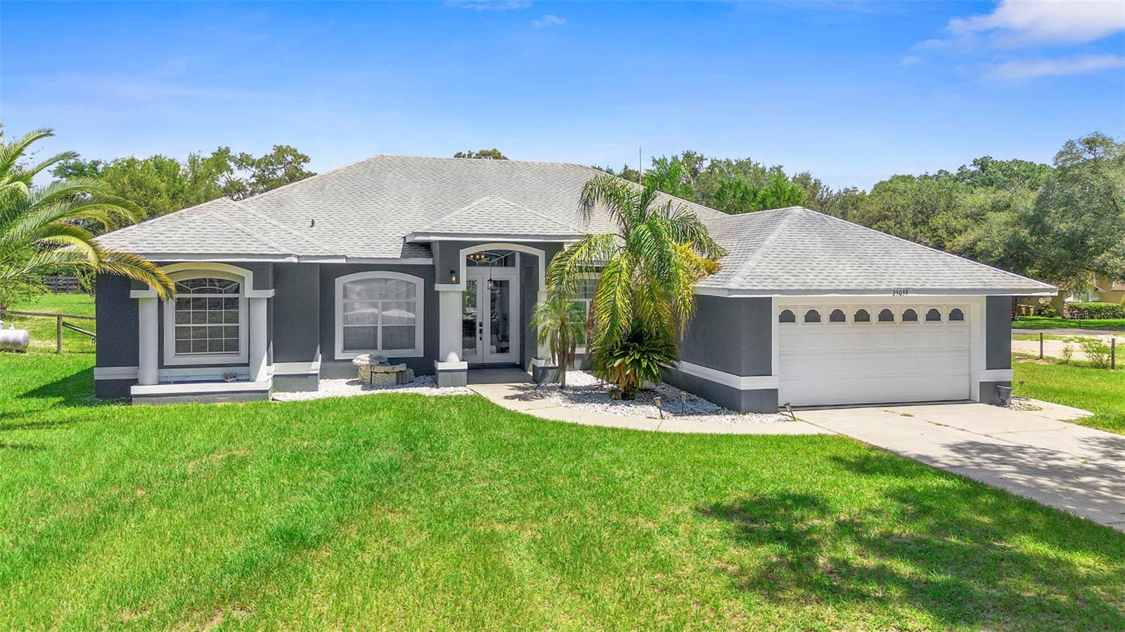 THE LIST PRICE REPRESENTS THE OPENING OFFER AMOUNT. AGENTS - PLEASE VIEW REALTOR REMARKS IN THE MLS.
Welcome to this BEAUTIFUL COUNTRY POOL HOME ON 1.7 ACRES with NO HOA, offering the perfect combination of PRIVACY, COMFORT, and ENTERTAINMENT. Built in 1999 and COMPLETED IN 2022, this spacious residence features 4 BEDROOMS PLUS A DEDICATED OFFICE that can easily serve as a 5TH BEDROOM if desired, along with a ROOF REPLACED IN 2018 for peace of mind. Inside you will find a HUGE FLORIDA/GAME/BONUS ROOM with a SUNKEN SPA and its OWN CENTRAL HVAC SYSTEM (square footage not reflected on listing), an OPEN KITCHEN with ISLAND, BREAKFAST BAR and PASS-THROUGH, and a HUGE MASTER SUITE with HIS AND HERS RAISED VANITIES WITH UNDERLIGHTING and a RELAXING GARDEN TUB. The home is wired for SURROUND SOUND STEREO throughout, offering the perfect atmosphere for gatherings. Step outside to enjoy the HEATED SWIMMING POOL, POOL COOL DECK, HOT TUB/SPA, and a DETACHED GARAGE with TWO ADJACENT 18’ x 21’ CARPORTS providing covered entertaining areas, plus a PARKING PAD FOR RV OR BOAT and the freedom to HAVE ONE HORSE PER ACRE. Beyond the property, the location is ideal—just 3 MILES FROM ROCK SPRINGS/KELLY PARK, a POPULAR TOURIST DESTINATION known for its CRYSTAL-CLEAR SPRING where families spend the day swimming and tubing, and only 12 MILES FROM WEKIWA SPRINGS STATE PARK, another ICONIC ATTRACTION with natural springs perfect for SWIMMING, KAYAKING, TUBING, and HIKING through scenic trails. This home is truly a PRIVATE OASIS in the heart of Central Florida.
Please contact the listing agents to schedule showings.
Offers will be accepted through Friday, September 5, 2025 at 4:00 pm.
AT SELLER'S DISCRETION, AN OFFER MAY BE ACCEPTED AT ANY TIME.