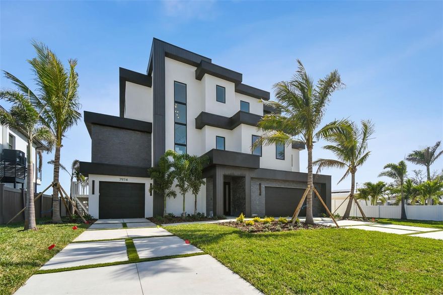 Welcome to the "New Normal" in Causeway Isles, featured is a stunning new construction luxury waterfront single-family residence just steps away from the pristine shores of Treasure Island and the inviting Treasure Island Beach in sunny St. Petersburg, Florida. This exquisite 3-story gem boasts 4 spacious bedrooms, including a dedicated office space, and 4 and a half elegantly designed bathrooms, offering an impressive 3,804 square feet of heated living space and a total of 6,598 square feet of gross area. Sleep soundly each night knowing your home is able to withstand Extreme Hurricanes like Milton and Helene with zero damage and absolutely no flooding! Enjoy seamless access with a private elevator connecting the garage to the top floor, making every level of this luxurious home easily accessible. Adorned with warm, earthy finishes and high-end fixtures, this residence exudes a welcoming yet sophisticated ambiance. Dive into your modern swimming pool, relax at your private boat dock, and savor the breathtaking waterfront views that stretch to the beachside. This exceptional property not only promises an ultimate luxury waterfront lifestyle but also places you in close proximity to shopping, dining, nightlife, and the tranquil beach. Experience the best of coastal living—your paradise awaits! Additional pictures coming!