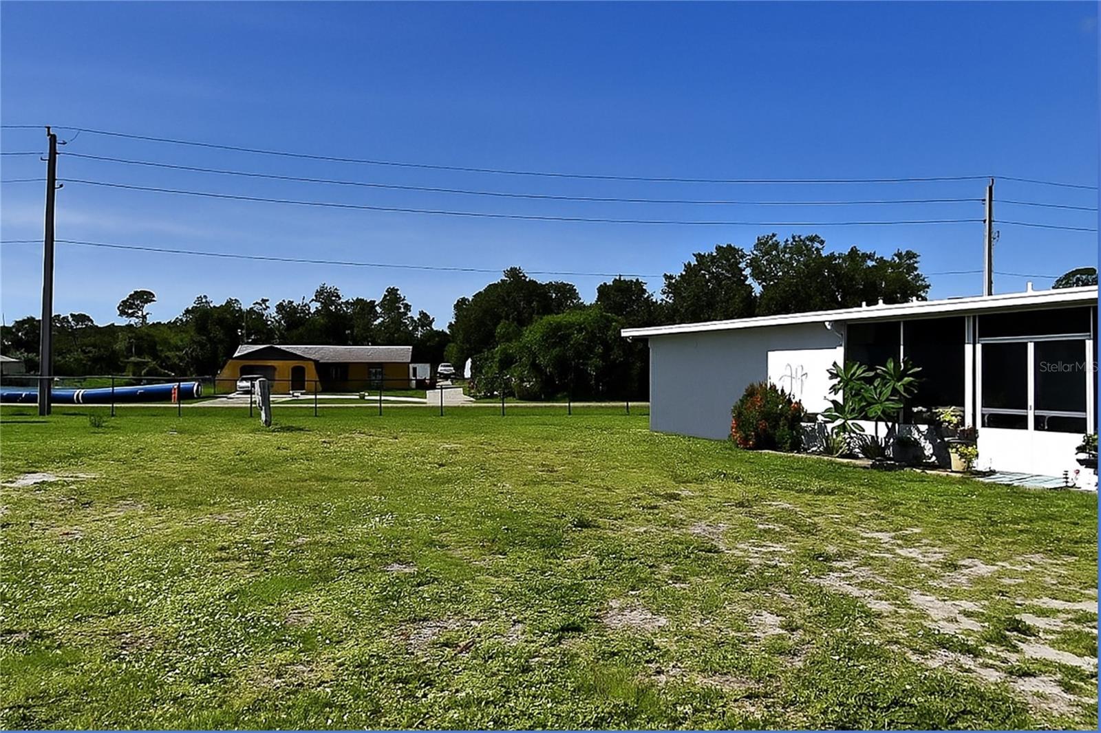 Welcome to an exceptional opportunity in the gated 55+ community of Holiday Park in North Port, Florida. This cleared vacant lot is perfectly positioned on Palena Blvd with rear access from Chancellor Blvd, and it's located in the desirable pet section where two small pets are welcome. One of the highlights of this lot is that the water meter is already installed and electricity is available, making it ready for your new manufactured home. Situated in an X flood zone, there is no requirement for flood insurance, offering peace of mind and added value.
In Holiday Park, you own the land with a deed, and the low annual maintenance fee of $2,340—just $195 per month—is conveniently included in your property taxes. The community is known for its vibrant lifestyle and wide range of amenities, including two swimming pools, tennis and pickleball courts, bocce, shuffleboard, a fitness room, a library, laundry facilities, and a busy clubhouse filled with activities like bingo and card games.
North Port is one of Southwest Florida’s fastest growing cities, offering easy access to shopping, dining, medical centers, golf courses, and beautiful Gulf beaches. Just a short drive away, you’ll find the cultural attractions of Sarasota, the historic charm of Venice, and the waterfront beauty of Englewood. Whether you're seeking a relaxing retirement or an active lifestyle, this lot in Holiday Park is the perfect place to build your Florida dream.