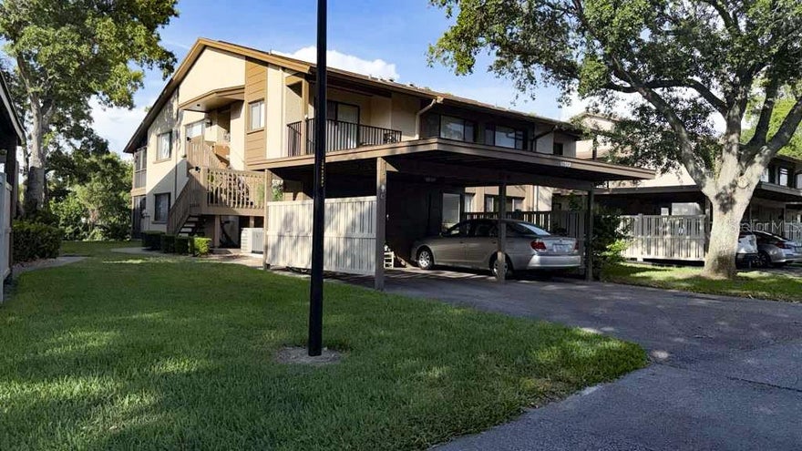 Live the Easy Florida Lifestyle in Beacon Woods Village! This beautifully maintained and freshly painted first-floor 2-bedroom, 2-bath condo offers peaceful golf course views and effortless living in the desirable 55+ community of Beacon Woods. No stairs, no elevators — just convenient ground-level access in this bright and welcoming 1st floor unit. 

Step inside this move-in-ready condo and enjoy an open, spacious floor plan with brand new laminate flooring throughout the main living areas. The efficient kitchen features ample cabinetry and workspace, with room for a small table. The washer and dryer are conveniently located inside the kitchen pantry area, making it easy to prepare meals while doing laundry. An enclosed patio off the kitchen with a private entrance is perfect for enjoying your morning coffee while soaking in the serene surroundings. The thoughtfully designed open layout flows seamlessly into the bright living and dining areas, creating a comfortable and airy feel. A cozy side room provides flexible space for crafts, reading, or a home office. The split-bedroom design ensures maximum privacy, with the guest bedroom conveniently located near a full bath and the primary suite featuring its own ensuite bathroom.

Relax on the screened vinyl-enclosed lanai overlooking the lush golf course with no rear neighbors — pure tranquility. Additional features include a dedicated covered carport with attached storage shed. This first-floor condo is part of the well-run Beacon Woods community, known for its picturesque golf course, mature trees, and extensive amenities including a heated pool, hot tub, lighted tennis and pickleball courts, shuffleboard, bocce ball, exercise room, clubhouse with dances, cards, yoga, and seasonal events. 

Your low monthly fee of just $445 covers exterior maintenance, roof insurance, water, sewer, trash, cable TV, internet, and full access to all community amenities. You’ll only pay your electric bill!Located in a non-flood zone with no CDD, strong reserves, and a proactive board, this home offers true worry-free living. All appliances are included.

Important Details: One occupant must be 55+. No dogs are allowed (other quiet pets permitted with approval). Vehicle restrictions apply. The unit can be rented after 2 years of ownership. All dimensions are approximate — buyers are urged to verify all information and review association documents.

This home delivers exceptional value through its outstanding amenities, friendly community atmosphere, wonderful neighbors, and carefree lifestyle. It’s just a short drive to shopping, dining, medical facilities, and less than 45 minutes to beautiful St. Pete Beach.

Ready for the easy Florida lifestyle? Schedule your private showing today!