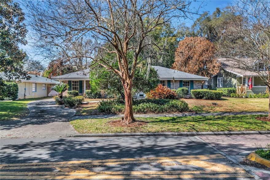 Nestled in the heart of Delaney Park, this charming 4-bedroom, 2-bath single-story home sits on an almost ¼-acre lot and offers the perfect blend of comfort, character, and opportunity. Move right in or bring your own design vision—this home features a fantastic, flexible floor plan with abundant storage and inviting living spaces throughout. A welcoming front porch sets the tone, ideal for relaxing evenings and friendly conversations with neighbors. Inside, the foyer opens to formal living and dining rooms filled with natural light and accented by crown molding and wainscoting. Sliding glass doors lead to the back patio, creating seamless indoor-outdoor flow. The cheerful kitchen offers bar seating and opens to the spacious family room, which also features sliding doors to the patio—perfect for entertaining. The private primary suite is thoughtfully positioned on one side of the home and includes a walk-in closet and a generously sized en suite bath. Three additional bedrooms are located on the opposite side, offering flexibility for guests, a home office, or multi-generational living. You’ll appreciate the extensive storage options, including bonus closets, attic space, and an oversized two-car garage. Step outside to a lushly landscaped backyard with plenty of room to customize and create your dream outdoor retreat. Located in one of downtown Orlando’s most desirable neighborhoods, this home is a short walk to Delaney Park’s tennis courts, playgrounds, and baseball fields, as well as Wadeview Park, Lake Davis and Lake Cherokee. Enjoy close proximity to Orlando Health and Arnold Palmer Hospital, the Dr. Phillips Center for the Performing Arts, Thornton Park, SODO, and the Hourglass District. Zoned for highly sought-after Blankner K-8 and Boone High School, this property offers an exceptional lifestyle in an unbeatable location. Additional updates include a 2018 roof and a 2025 A/C—providing peace of mind for years to come.